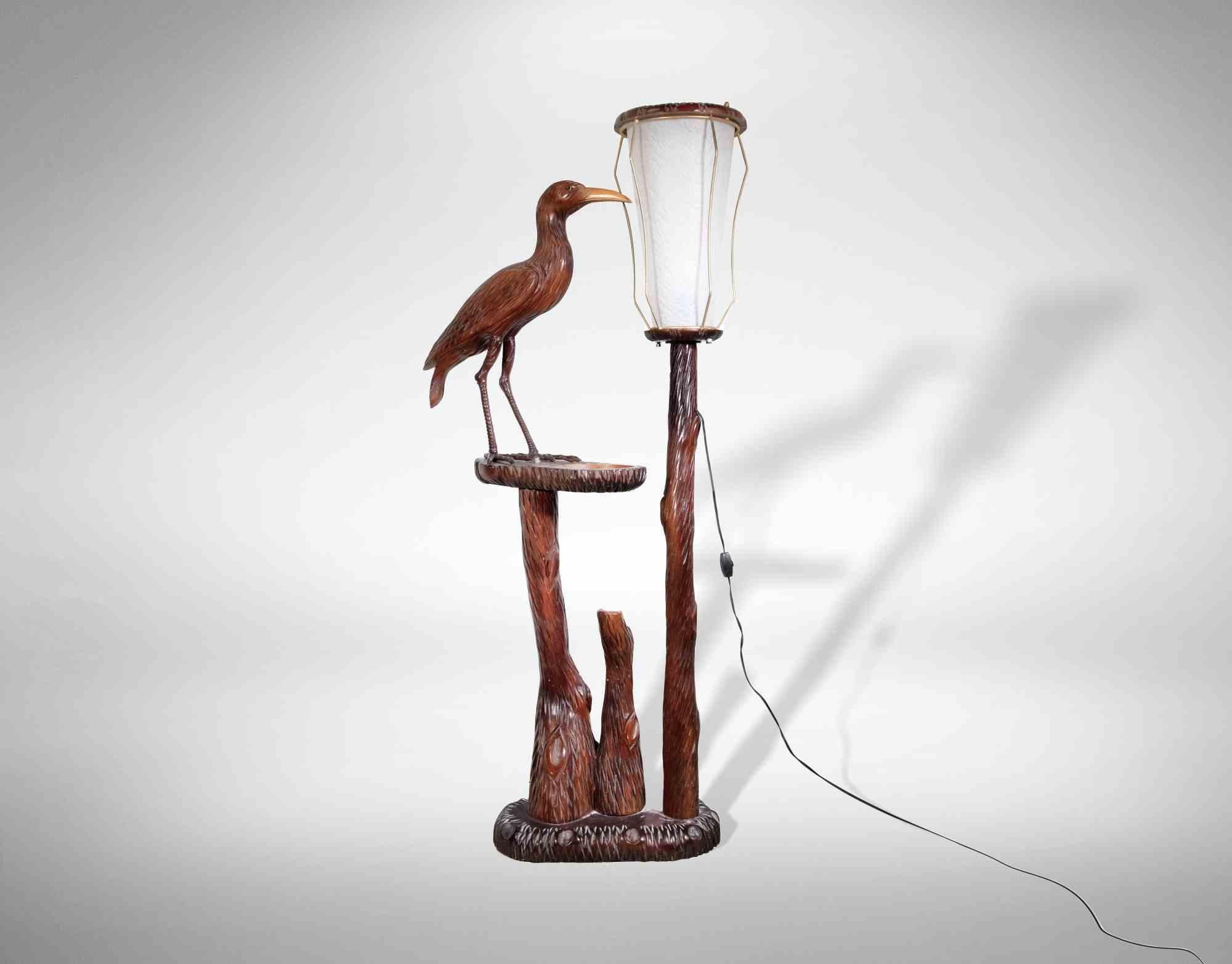 Vintage wooden lamp with bird is an original design lamp realized by Aldo Tura in the 1950s

A unique carved wooden floor lamp with parchment lampshade. The lamp has a wooden shelf with ashtray and a bird carved.

Aldo Tura (1909-1963), the