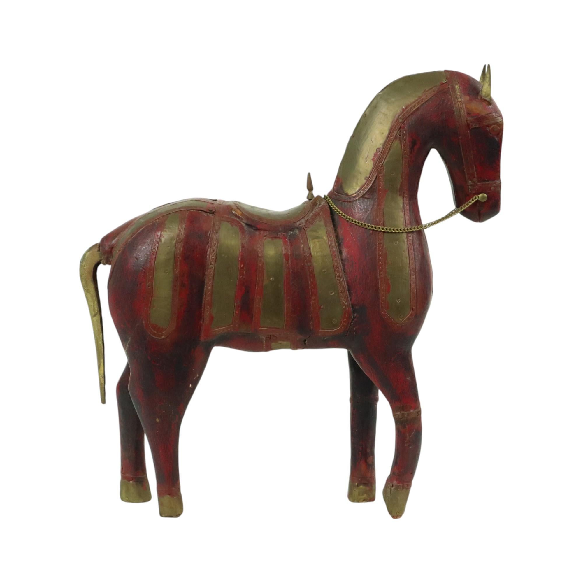 Vintage wooden Marwari horse covered with red and yellow copper, or brass, characterful horse statue, sculpture, from India, mid-20th century.

This beautiful statue is handmade from hardwood and is stained red, the statue has a very beautiful age
