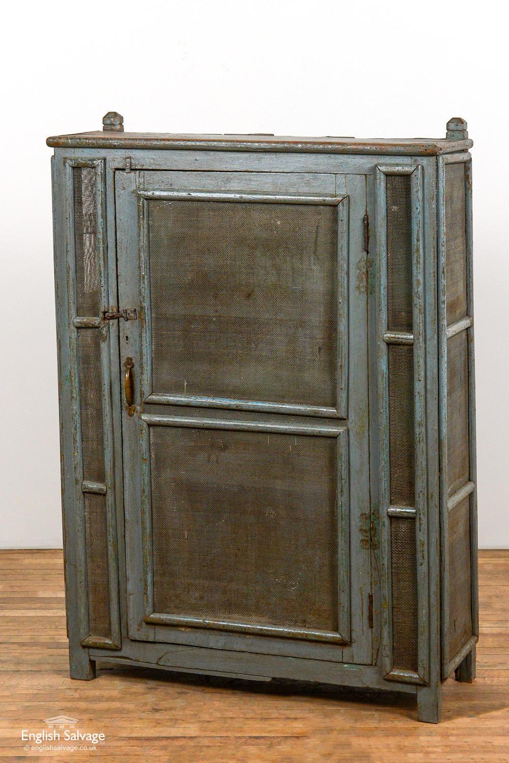Rustic wooden painted freestanding cabinet with planked shelves and mesh to the front and sides, making it ideal as storage in a pantry or kitchen. Chips, bumps and knock commensurate with age and style of the storage unit.