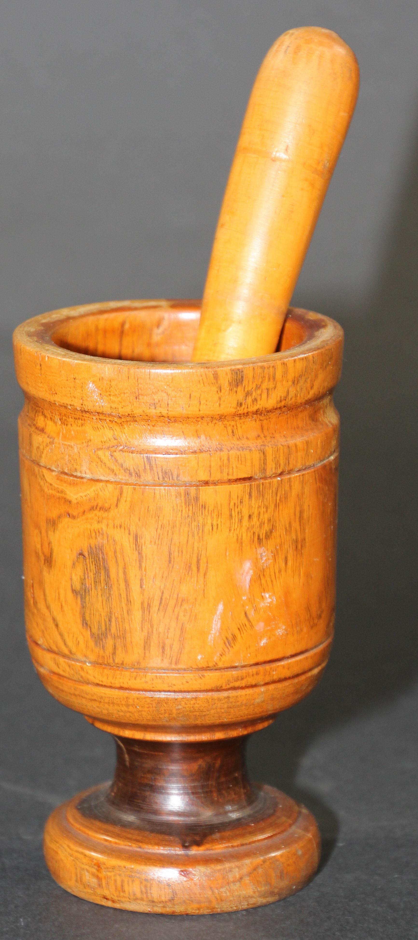 Wooden footed mortar and pestle hand turned and carved from one piece of dense fruitwood. 
Handcrafted by artisan in Italy, vintage Mid-Century Modern hand turned wood Mortar and Pestle.
Display it on your kitchen island or in a bookcase and just