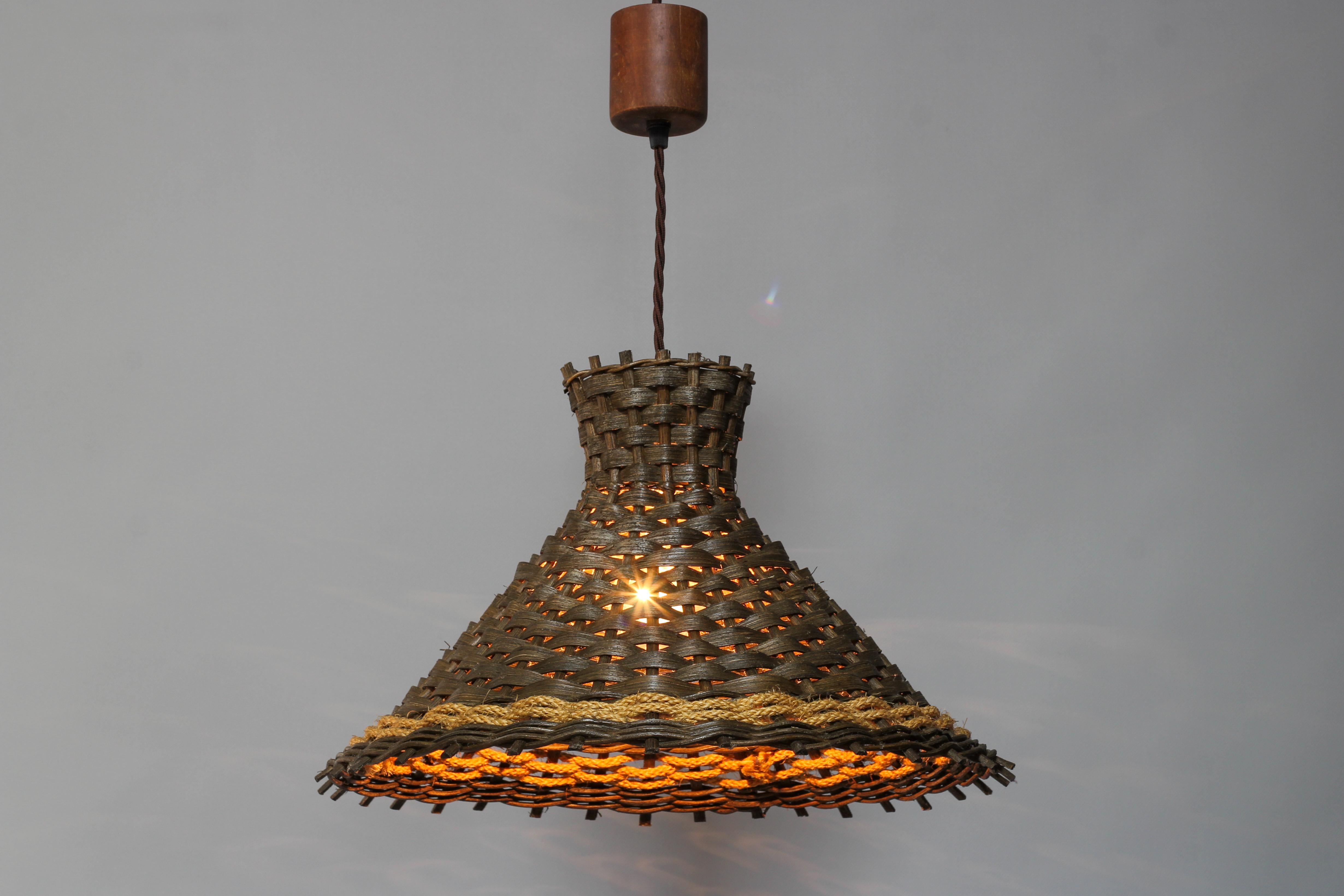 Adorable vintage, Mid-Century Modern wooden pendant lamp, Germany, the 1970s. Dark brown wooden lampshade adorned with a yellow accent - a braided rope. Wooden canopy.
One new socket for E27 (E26) size light bulb.
Dimensions: height: adjustable from