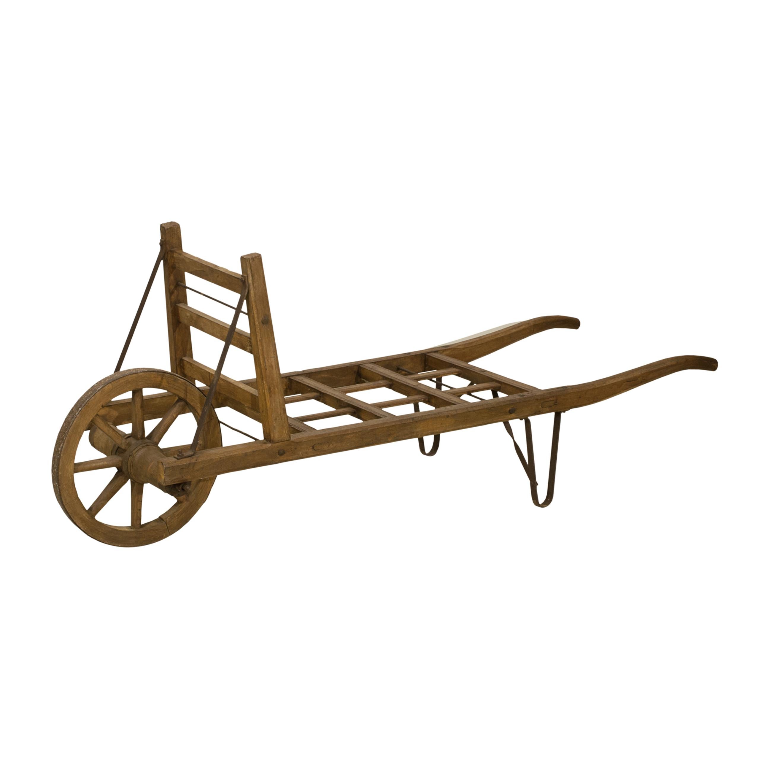 Antique Porters Trolly With Luggage, Hay Wheelbarrow.
A charming late 18th, early 19th century wooden barrow, made of beechwood with single wooden spoked front wheel with iron surround and two metal support feet to the rear. A great decorative piece