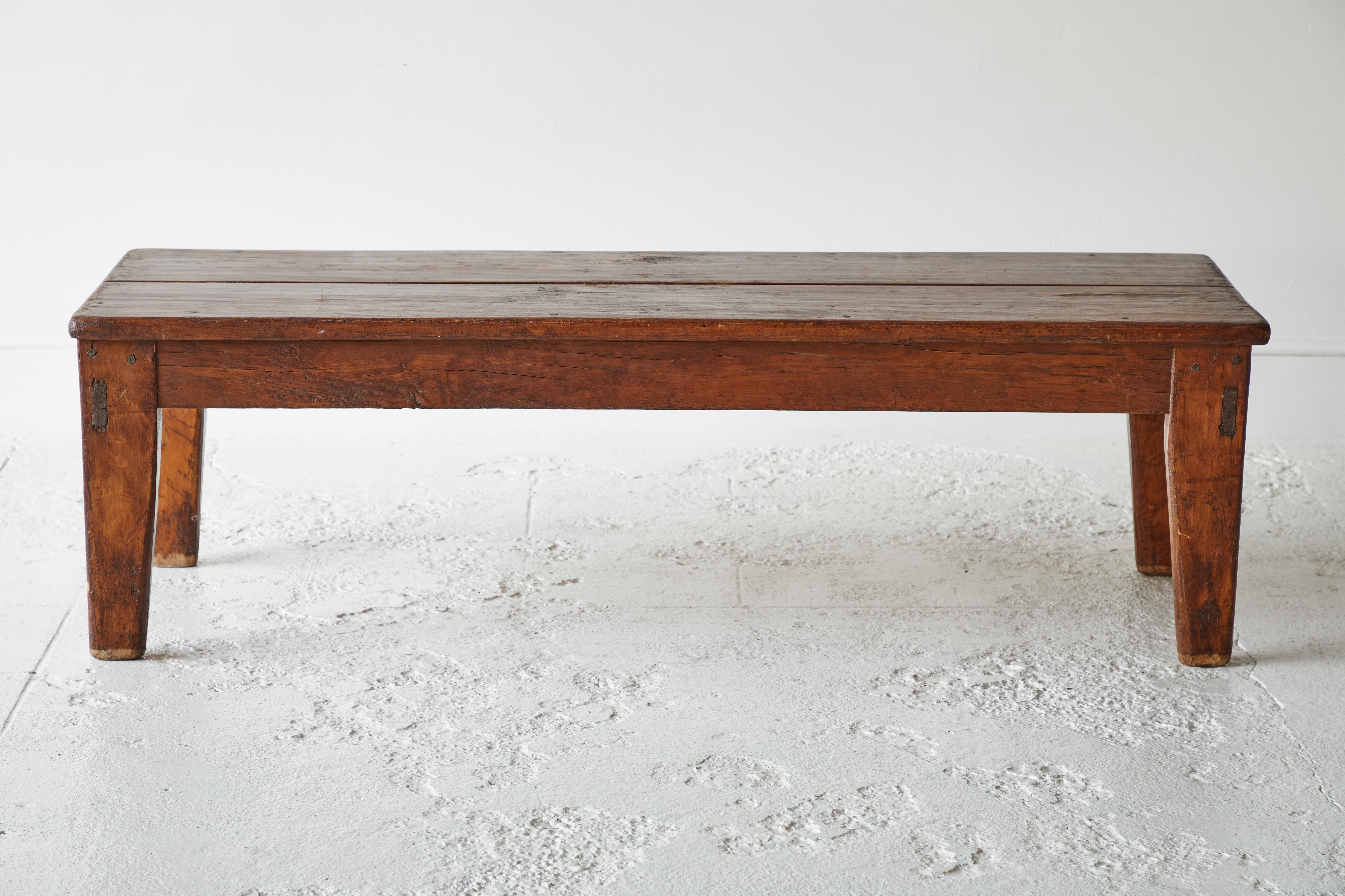 Vintage wooden rectangular coffee table that can also work as a bench. The top is comprised of two planks.