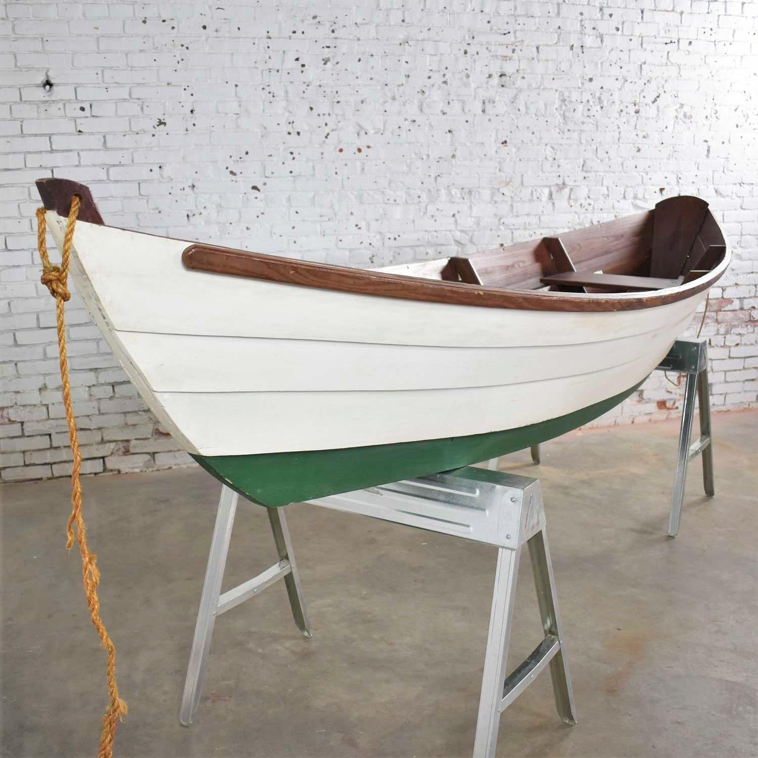 Oh, so fun vintage wooden rowboat to be used as maritime or nautical décor. It is in wonderful vintage condition with great natural age patina which includes peeling and chipped paint, cracks, and other wear. Will not float without modification.