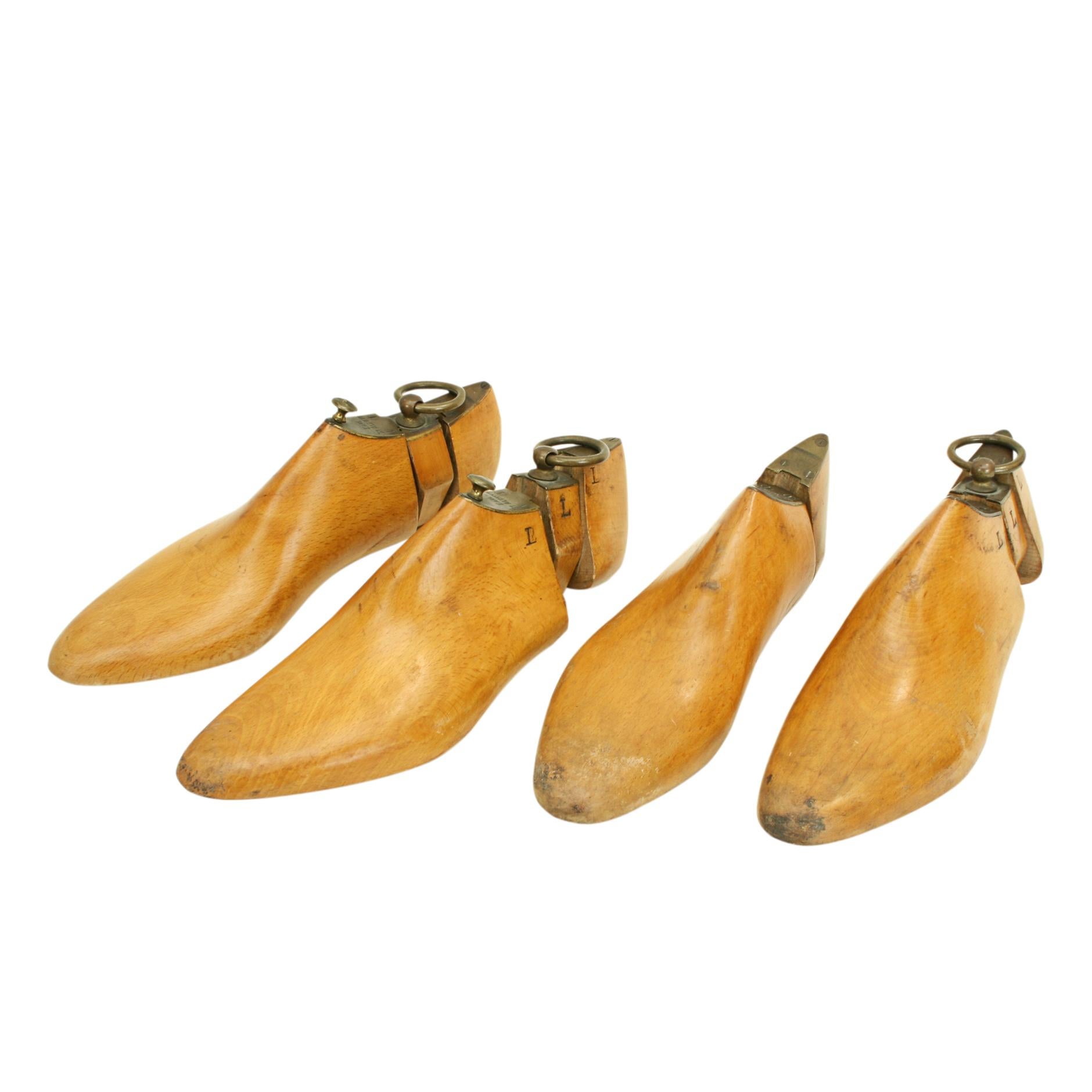 Vintage Wooden Shoe Trees, Earl St. Aldwyn.
Two pairs of beechwood shoe trees with a lovely golden patina. The shoe trees are made in three pieces with brass tops and pull rings. One set does have a missing center. The brass tops are engraved 