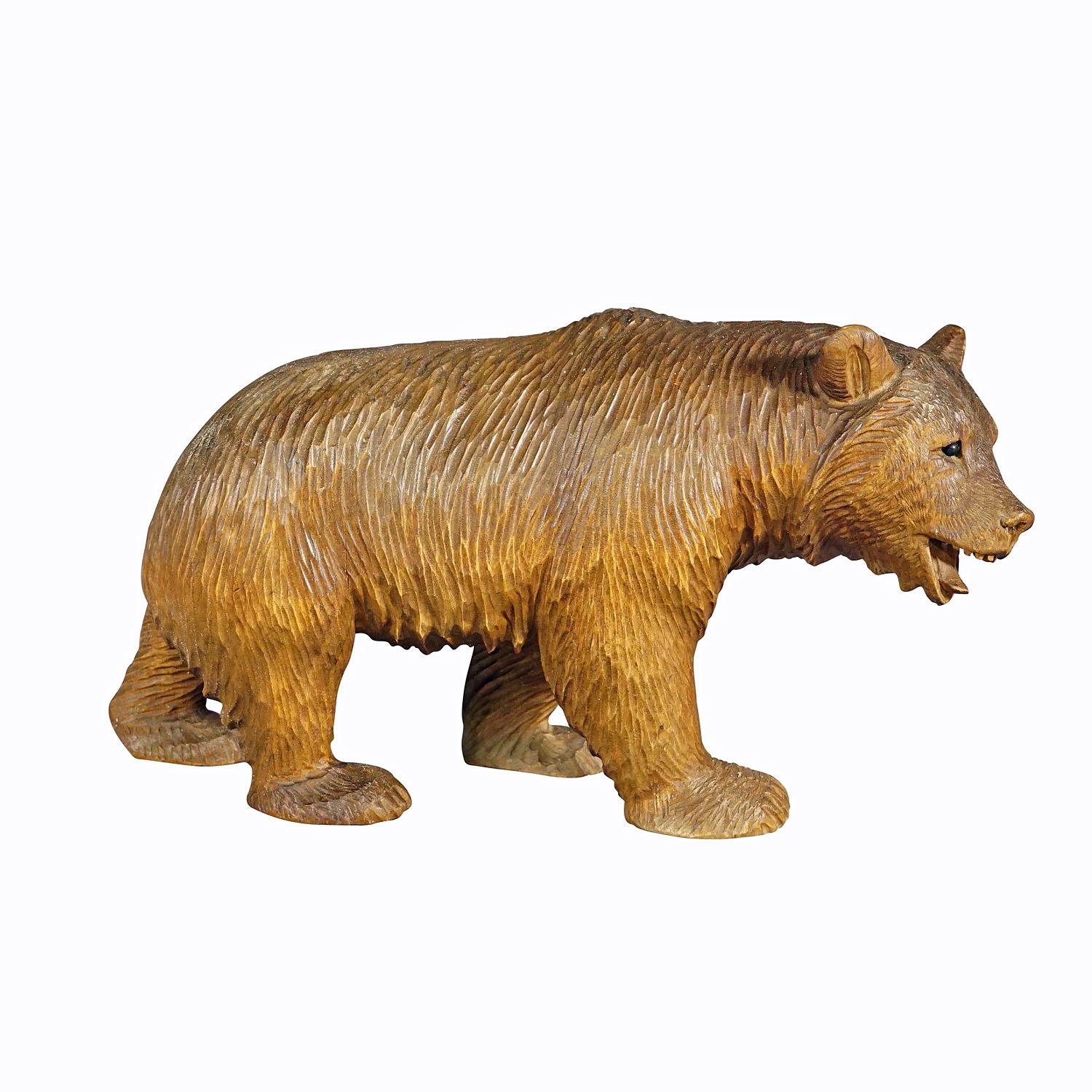 Vintage wooden strolling bear hand carved in Brienz, circa 1930s

A vintage statue of a walking bear. Made of lindenwood, finely hand carved with naturalistic details in Brienz, Switzerland ca. 1930s. A nice example of the famous Black Forest