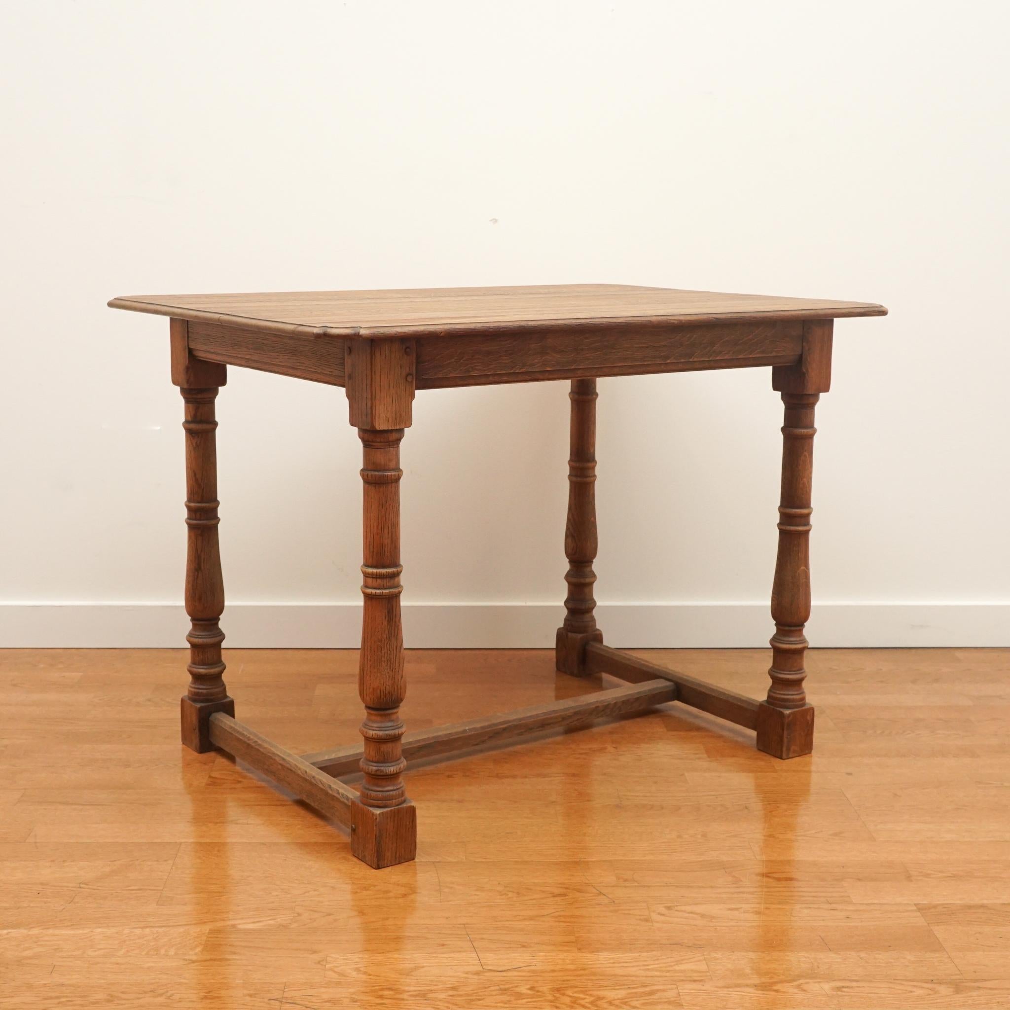  Beautiful wooden table with carved out corner details , turned legs and a low cross stretcher. Wonderful addition to any home.  