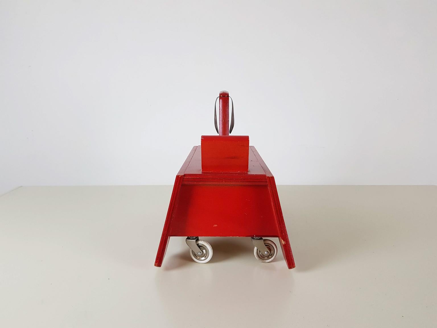 Just look at this happy vintage dog from the 1950s! This post-war wooden dog on wheels was made and designed by German toy manufacturer Konrad Keller Holzspielwaren. The red dog has seating place for a kid and can be used as a toy car.

A