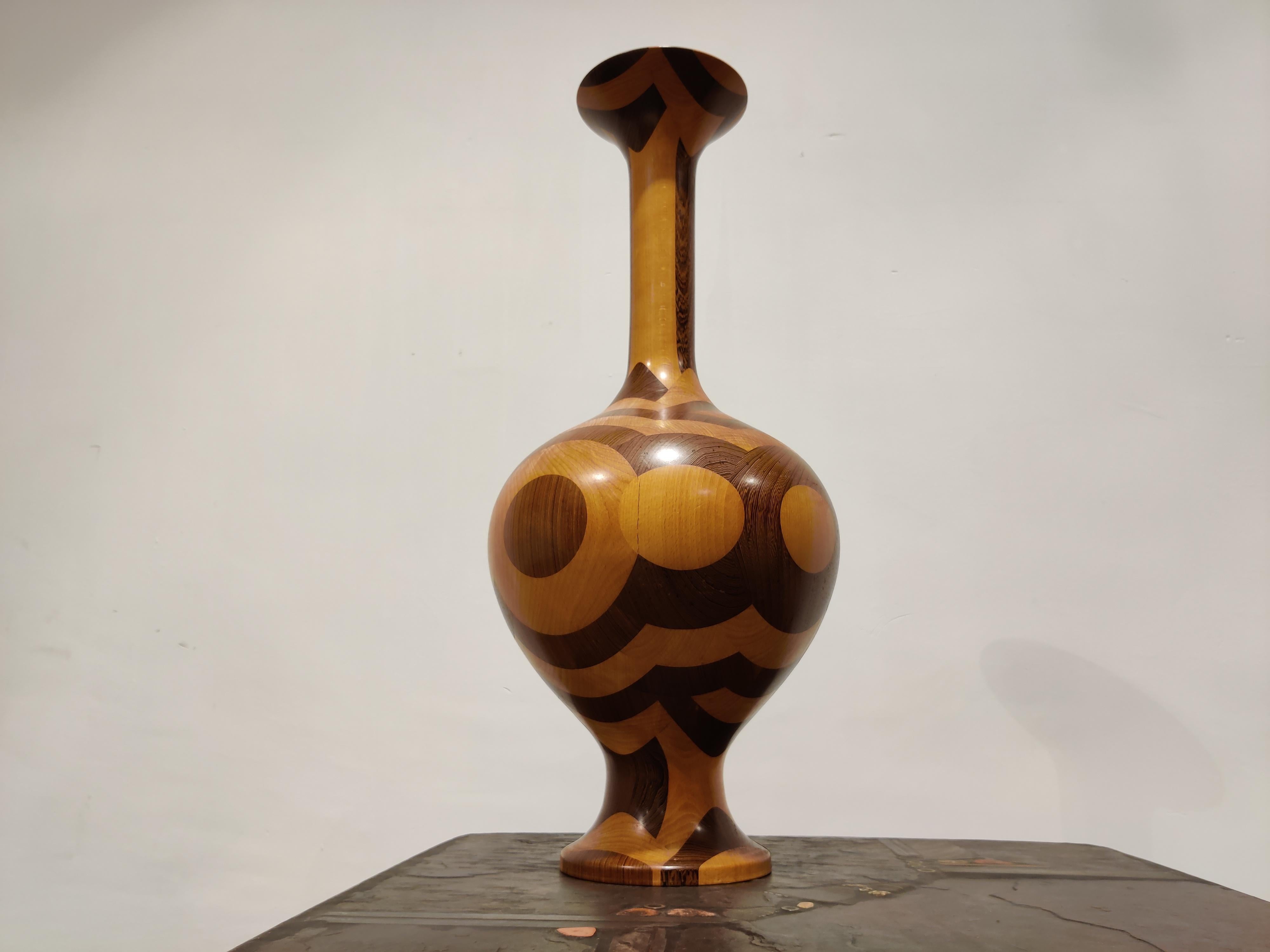 Elegant organic shaped wooden vase with inlaid wood by Decoene.

The use of different types of wood together with the fine shape of the vase is what makes this piece a treat for the eyes.

Manufactured by renowned Belgian furniture maker