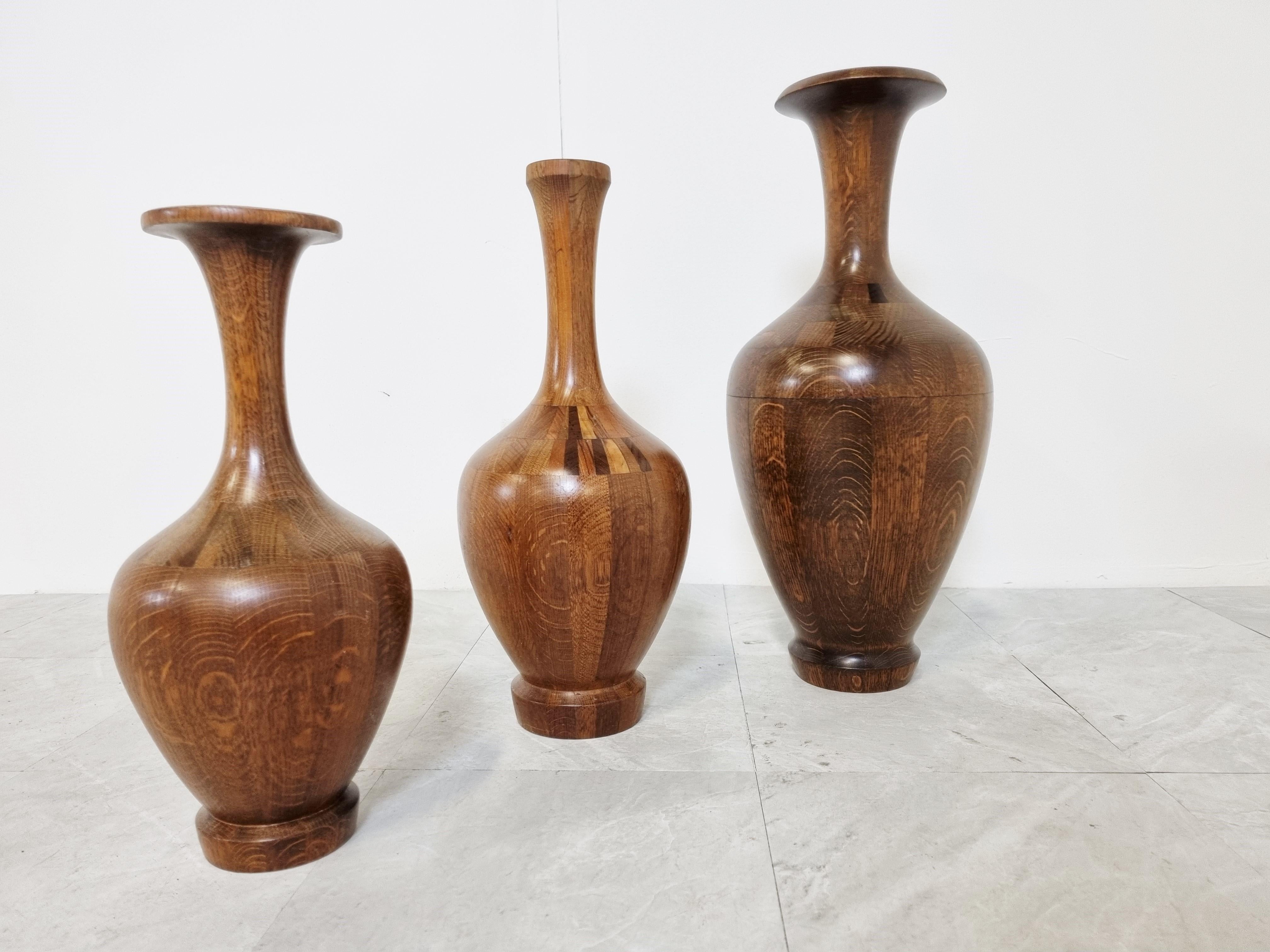 Set of 3 elegant vases by Maurice Bonami, commonly attributed to Decoene.

Real craftsmanship was needed to create these beautiful vases consisting of different specimens of wood.

Good condition with normal age related wear.

Sold as a set