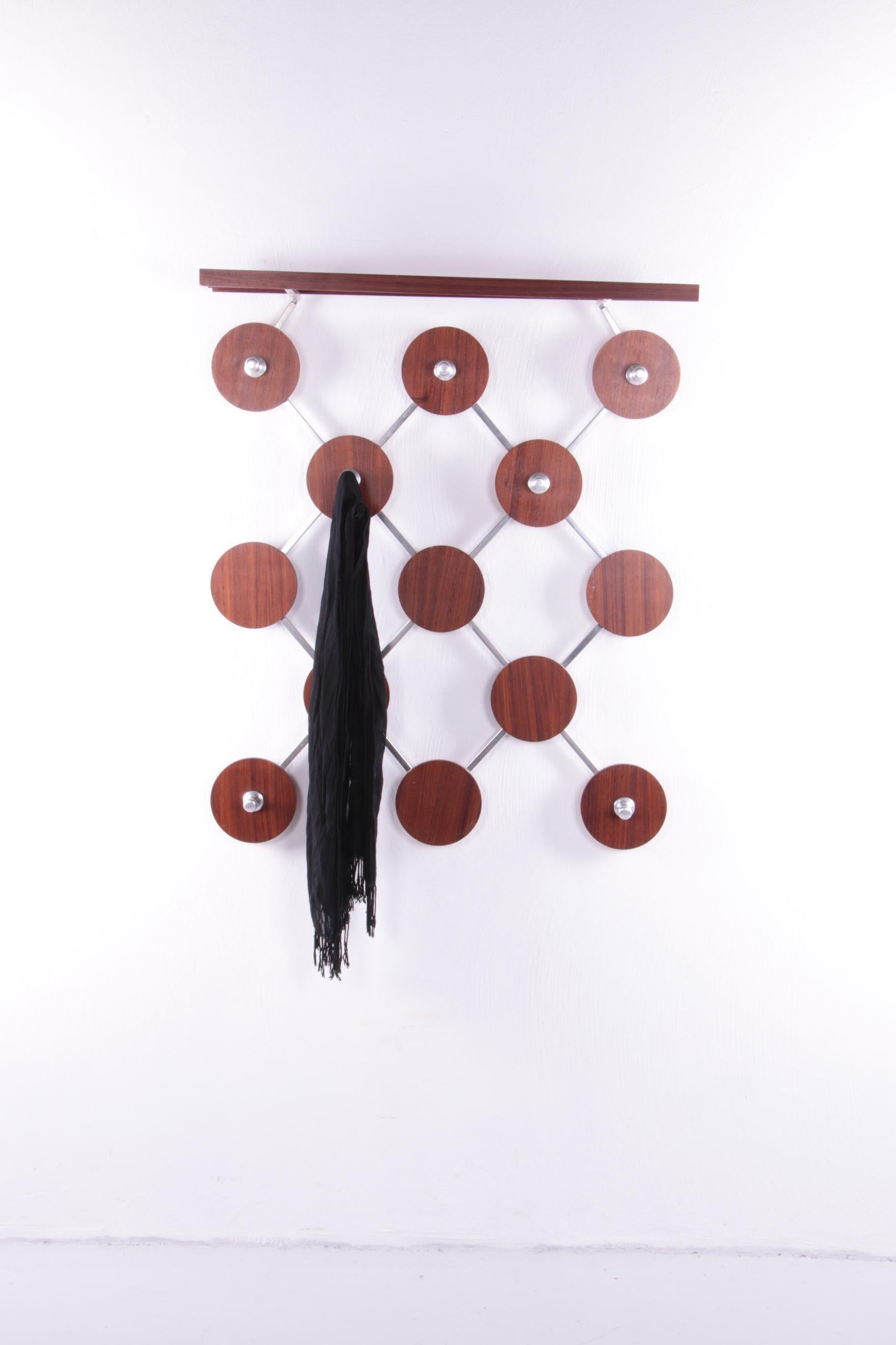 Vintage wooden wall coat rack with hat shelf, 1960s.


A beautiful example of sturdy and striking German design. This stylish wall coat rack will be a unique addition to any hall.

Made of solid wood and veneer.

The coat rack is made of
