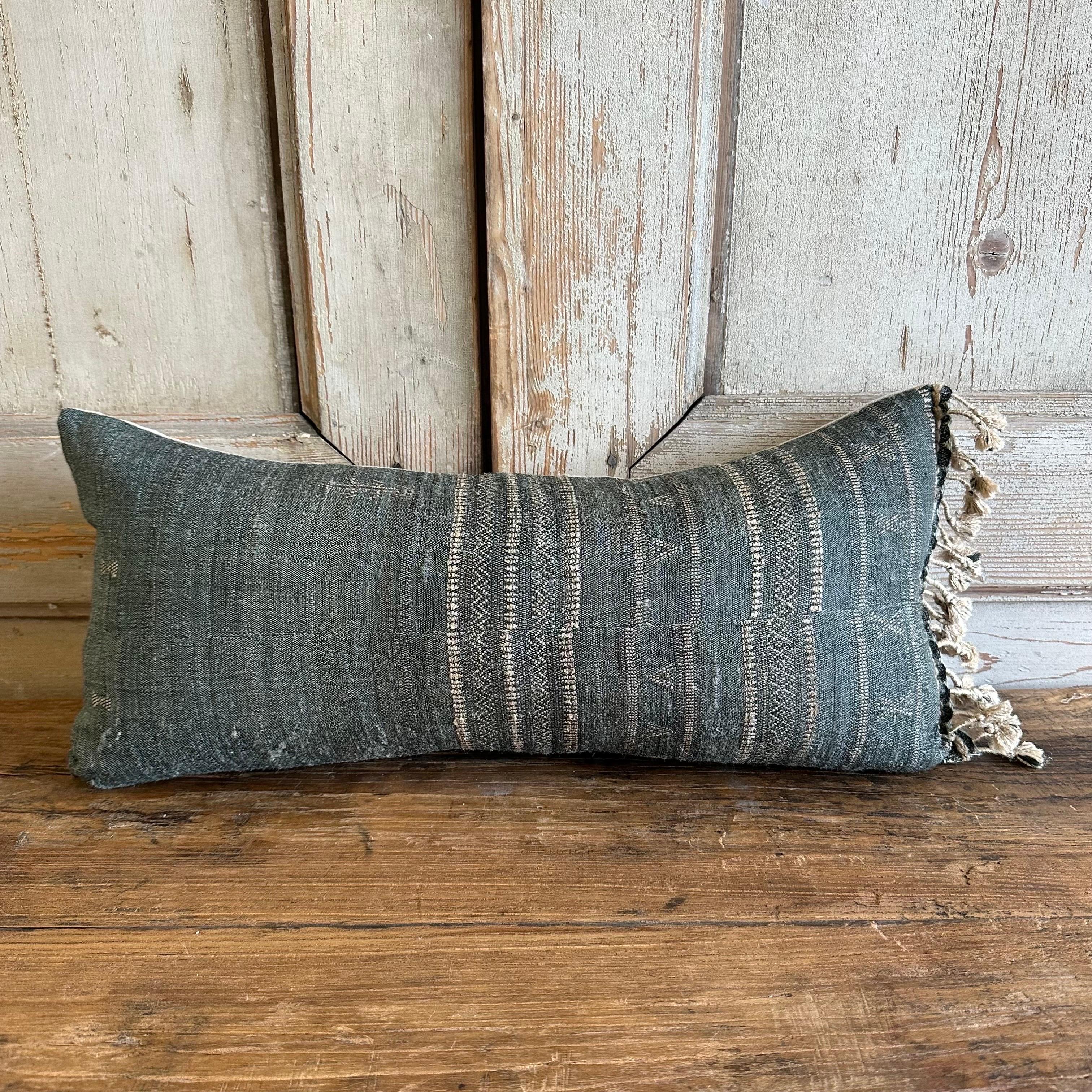 A beautiful linen, wool and silk pillow made from vintage textiles. 
The backing is a solid natural linen, with hidden zipper closure, and down/feather insert.
In a denim, indigo faded color, with natural embroidery and natural tie tassels, this