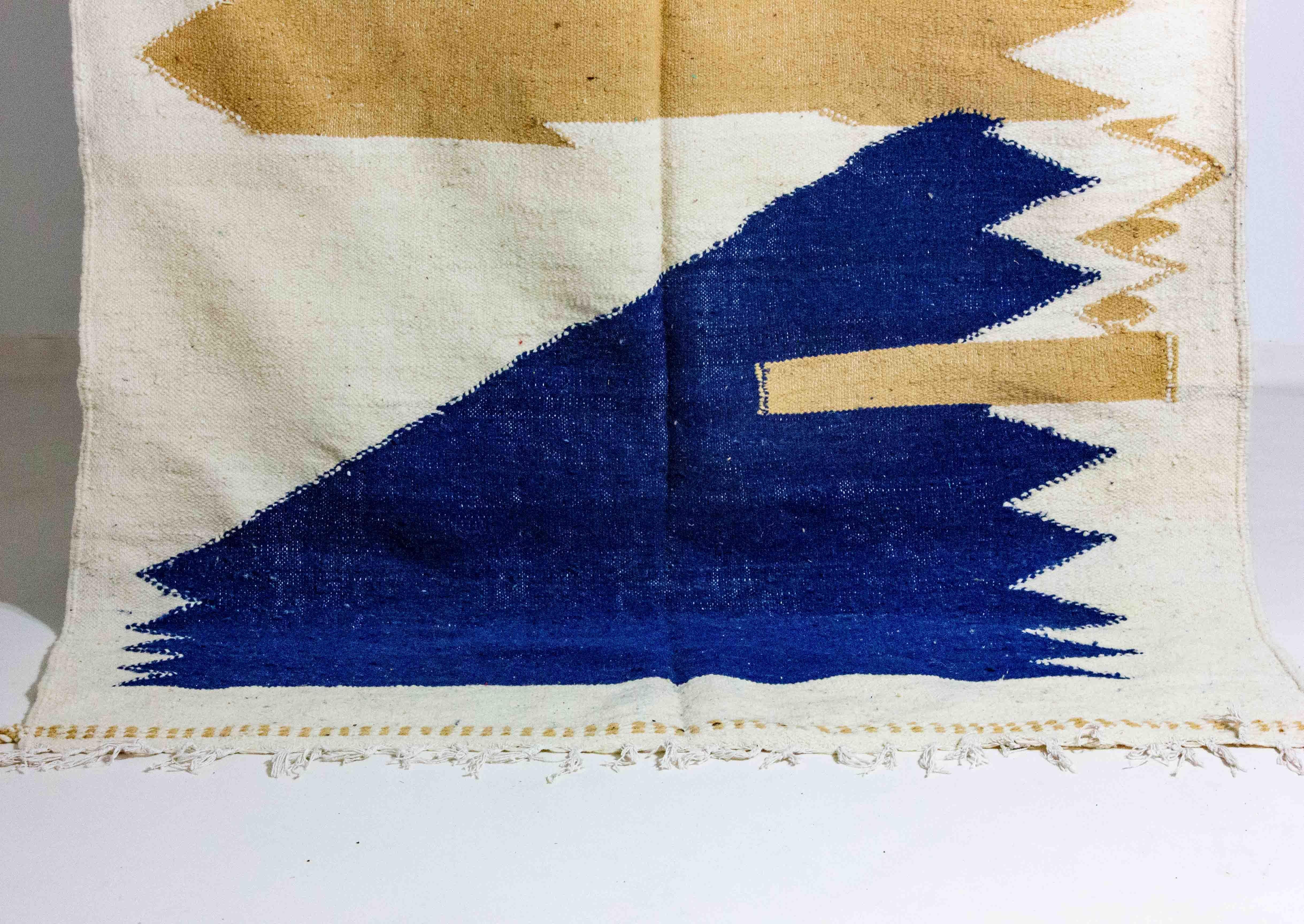 Vintage Tribal Moroccan Berber Rug: This striking rug features a mix of beige, camel brown and deep cove blue, crafted with natural, organic dyes. A stunning example of Abstract Modernist Art, it originates from the Atlas Mountains of Morocco and