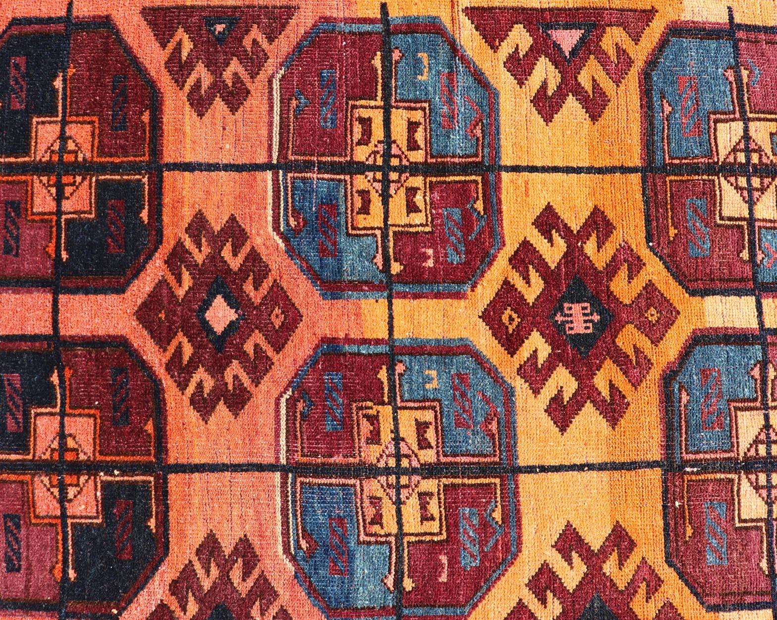 Hand-Knotted Vintage Wool Ersari Rug in Wool with Gul Design in Orange, Blue, and Brown For Sale
