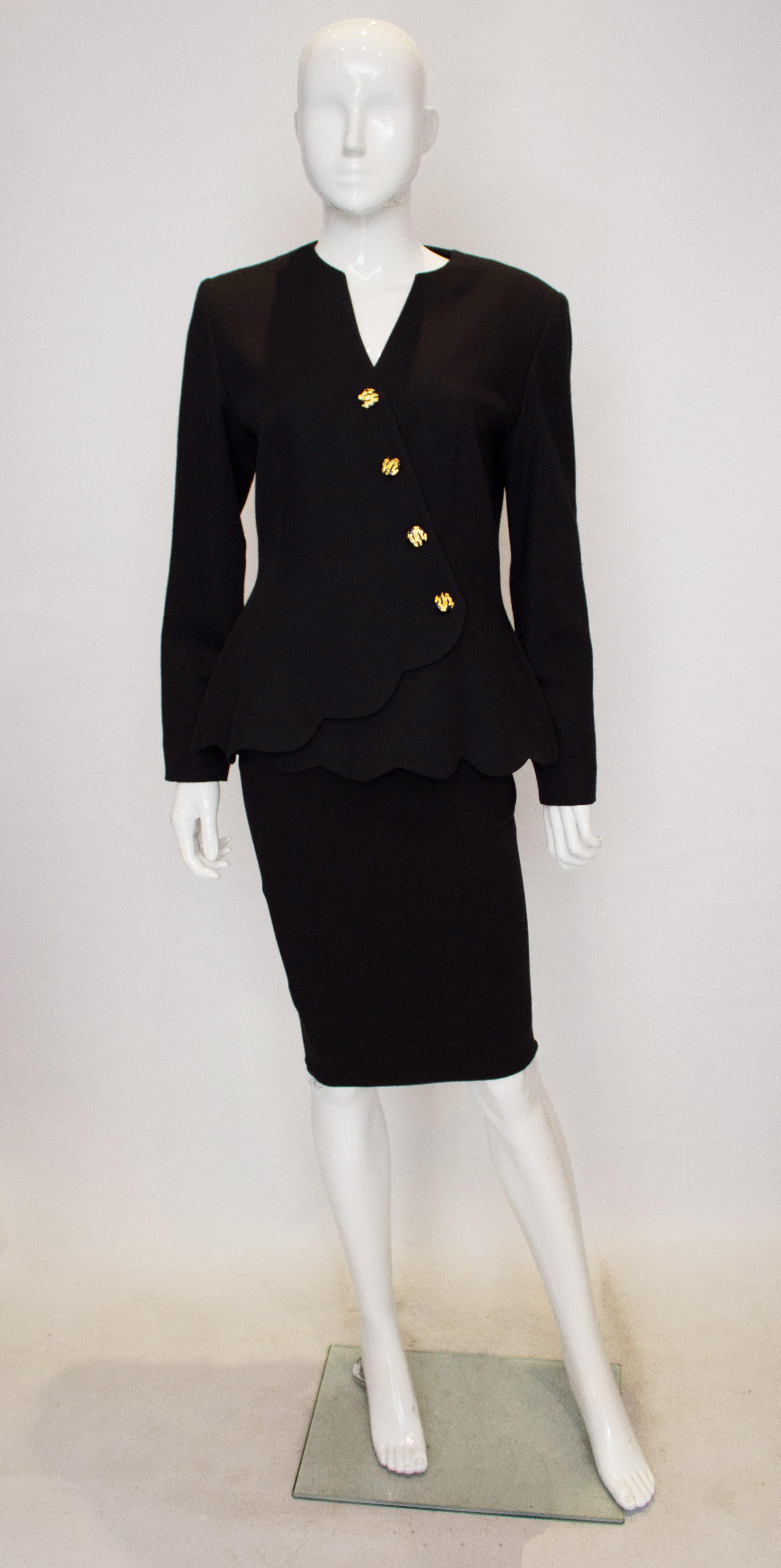 A chic vintage wool jacket by Peter Barron. The jacket has a wonderful neckline with diagonal fastening with gilt and navy/black buttons. It has a scalloped hem and is fully lined. 