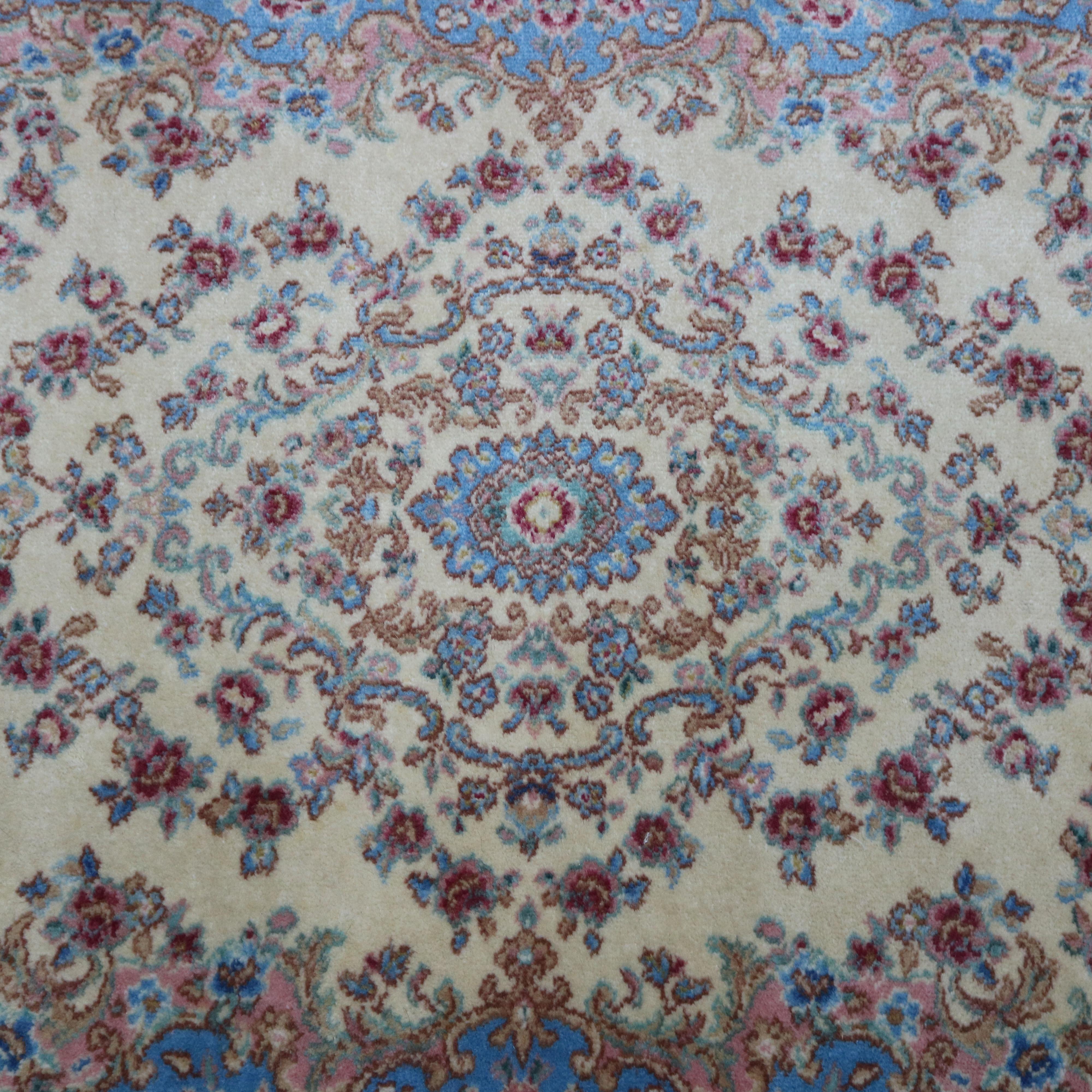 A vintage Kirman Oriental rug by Karastan offers wool on cotton construction with central floral medallion on ivory ground with blue spandrels, pattern Ivory Medallion #711, en verso original label as photographed, circa 1950.

Measures: 79.5