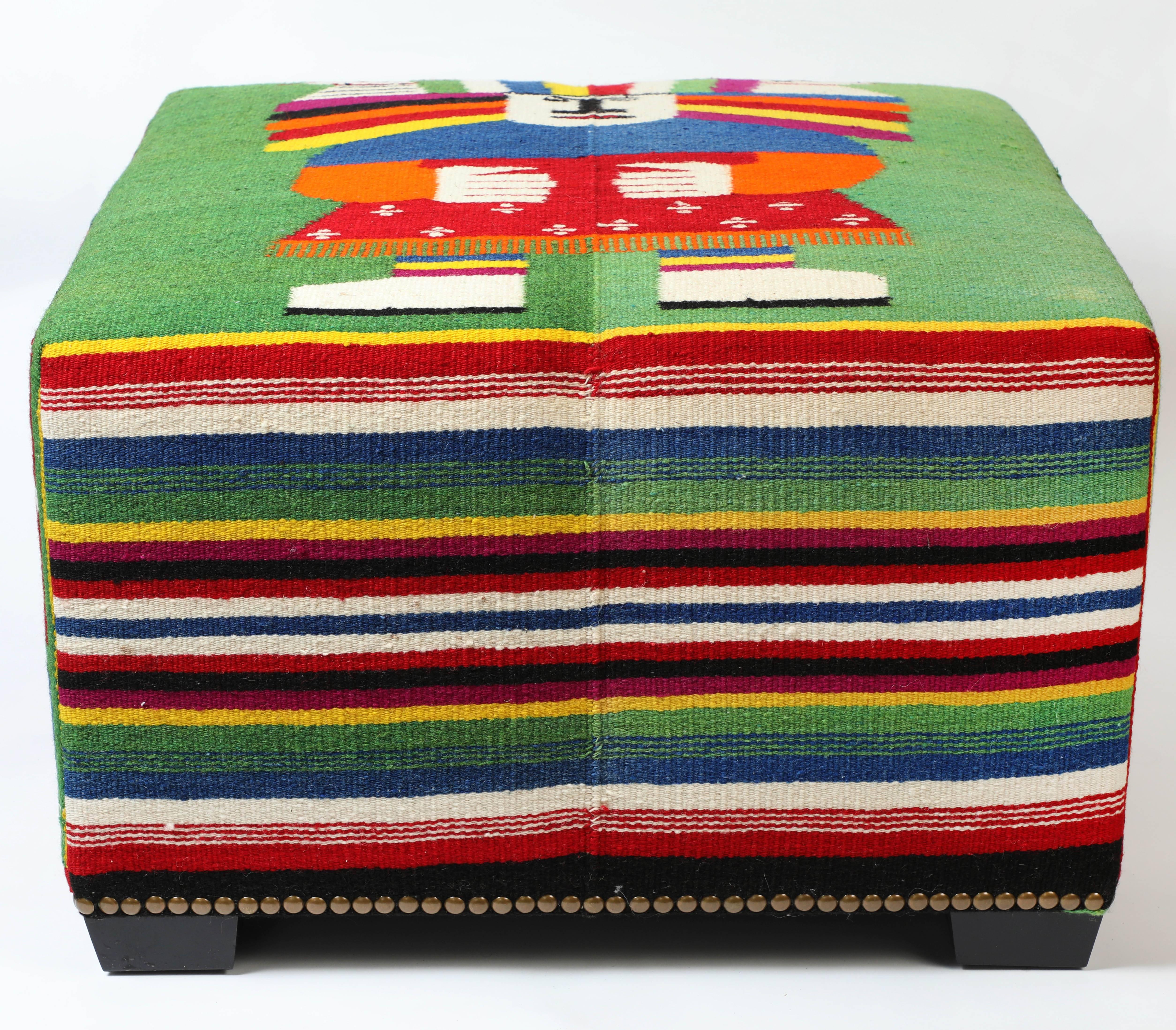 Limited Edition Cube combine vintage textiles with custom-scaled pieces to create interesting and useful accent seating. Each piece is one of a kind.

This custom-made ottoman with wood feet and nailhead trim features a colorful woven vintage