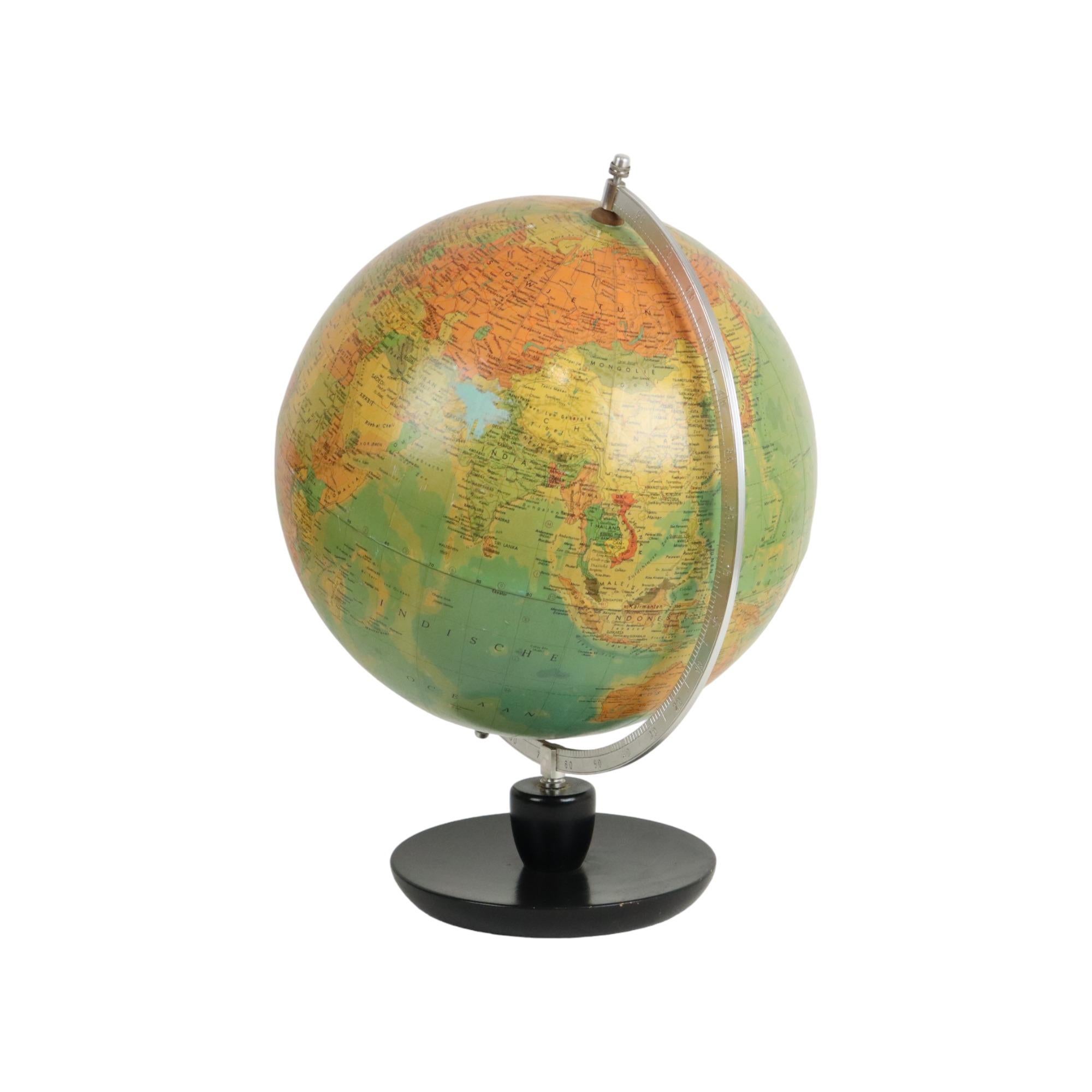 Beautiful vintage Dutch globe on a black lacquered oak round base, published by Hermann Haack Gotha for Räth, 1950s, scale 1:38 600 000.

This globe was made in the GDR, made of hard cardboard, with a silver-colored metal protractor and a round