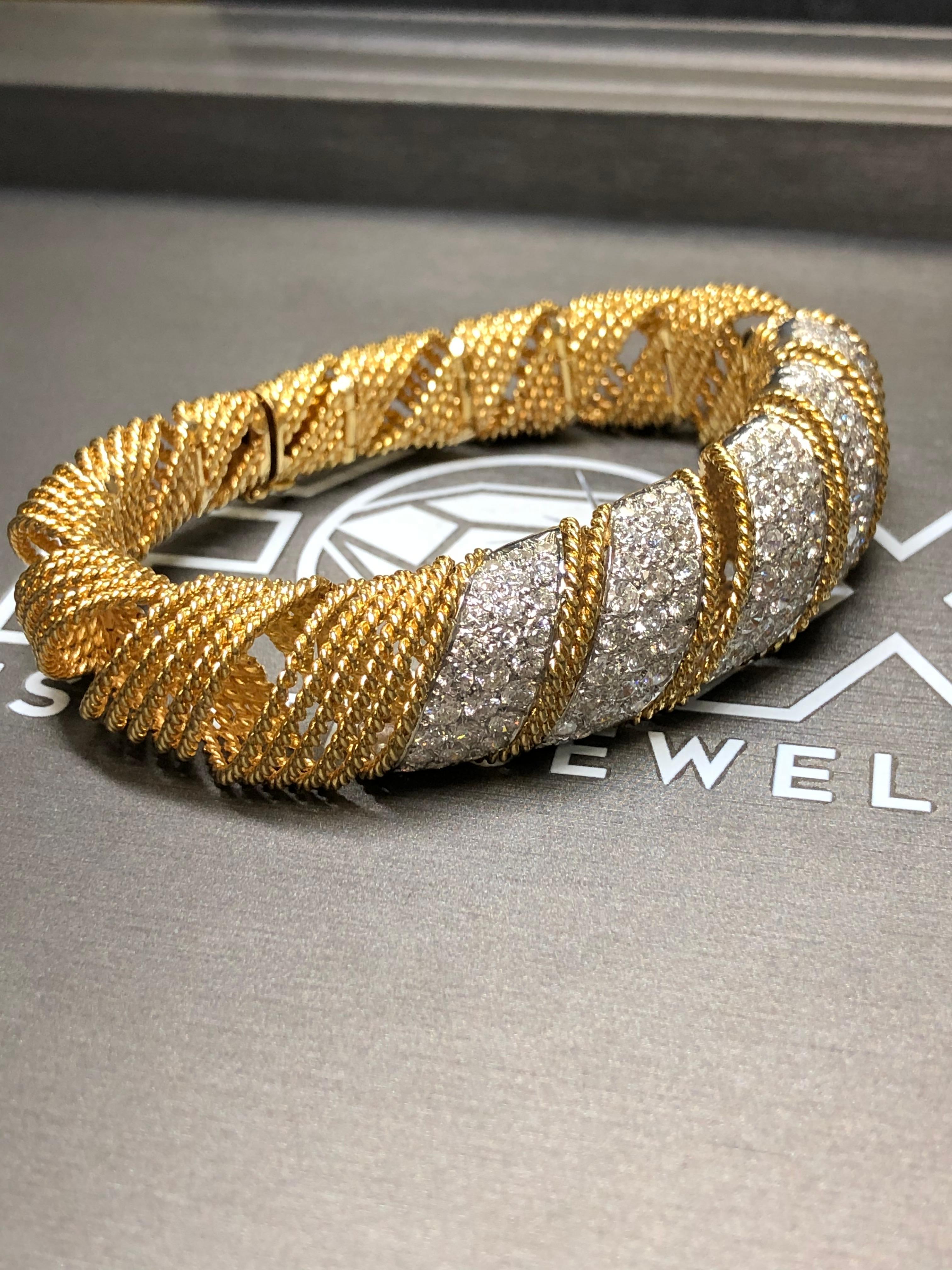 An incredible bracelet circa 1960’s done in 18K and set with approximately 9.20cttw blindingly white F-G color Vs clarity rounds diamonds. This bracelet also has a graduated design that tapers down towards the clasp which allows it to lay and wear