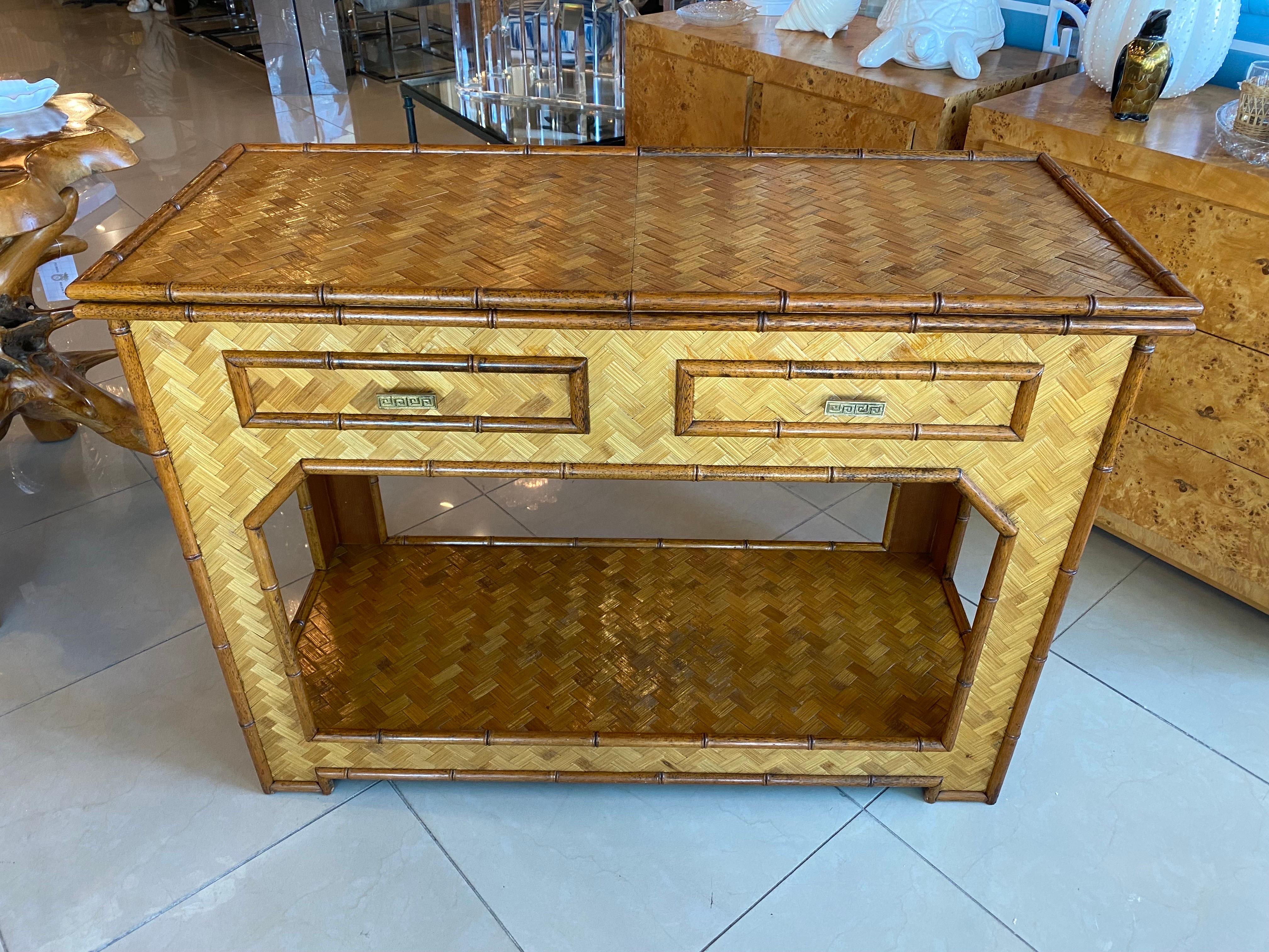 Vintage Woven bamboo console table with 2 drawers desk. Moroccan Arches accent this piece giving it a special look! Brass Greek Key drawer pulls. Lovely wood bamboo trim all around. The back side of this is also finished so it can float in a room
