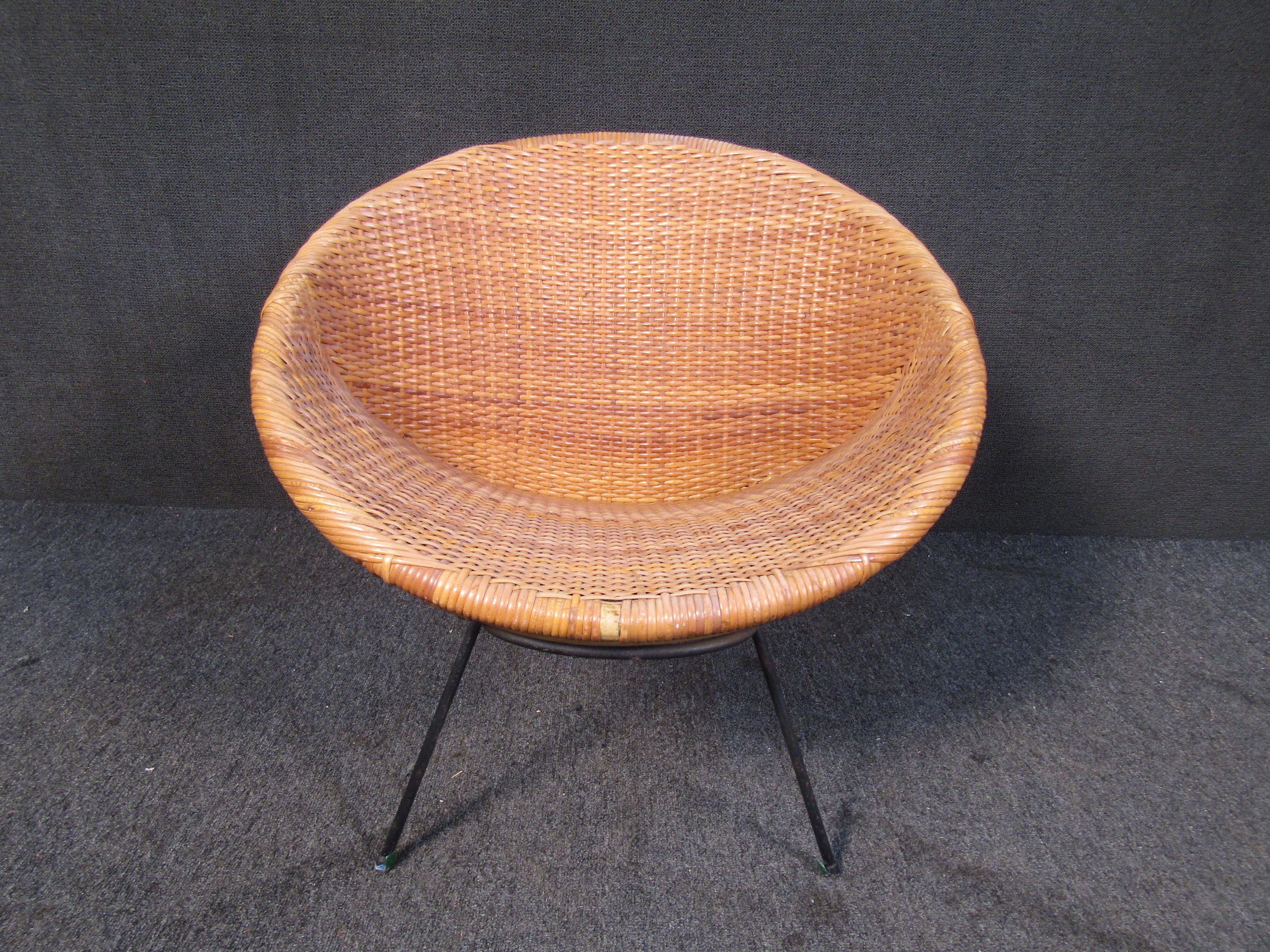 This vintage cane chair shows off a round design that offers style in a Mid-Century Modern design. The chair is completed by a woven cane surface that is comfortable and easy to clean. Please confirm item location with seller (NY/NJ).