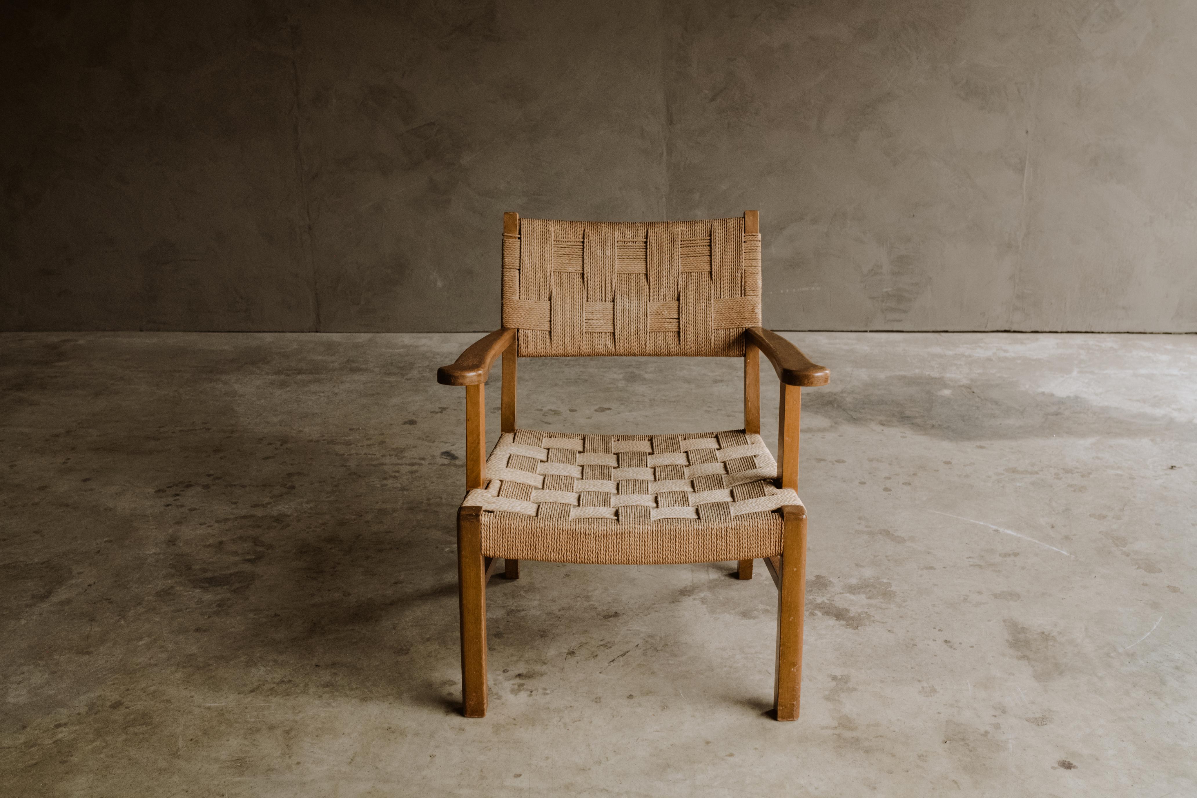 Vintage woven lounge chair from France, Circa 1970. Solid beech frame with original woven paperboard seat and back. Nice wear and patina.