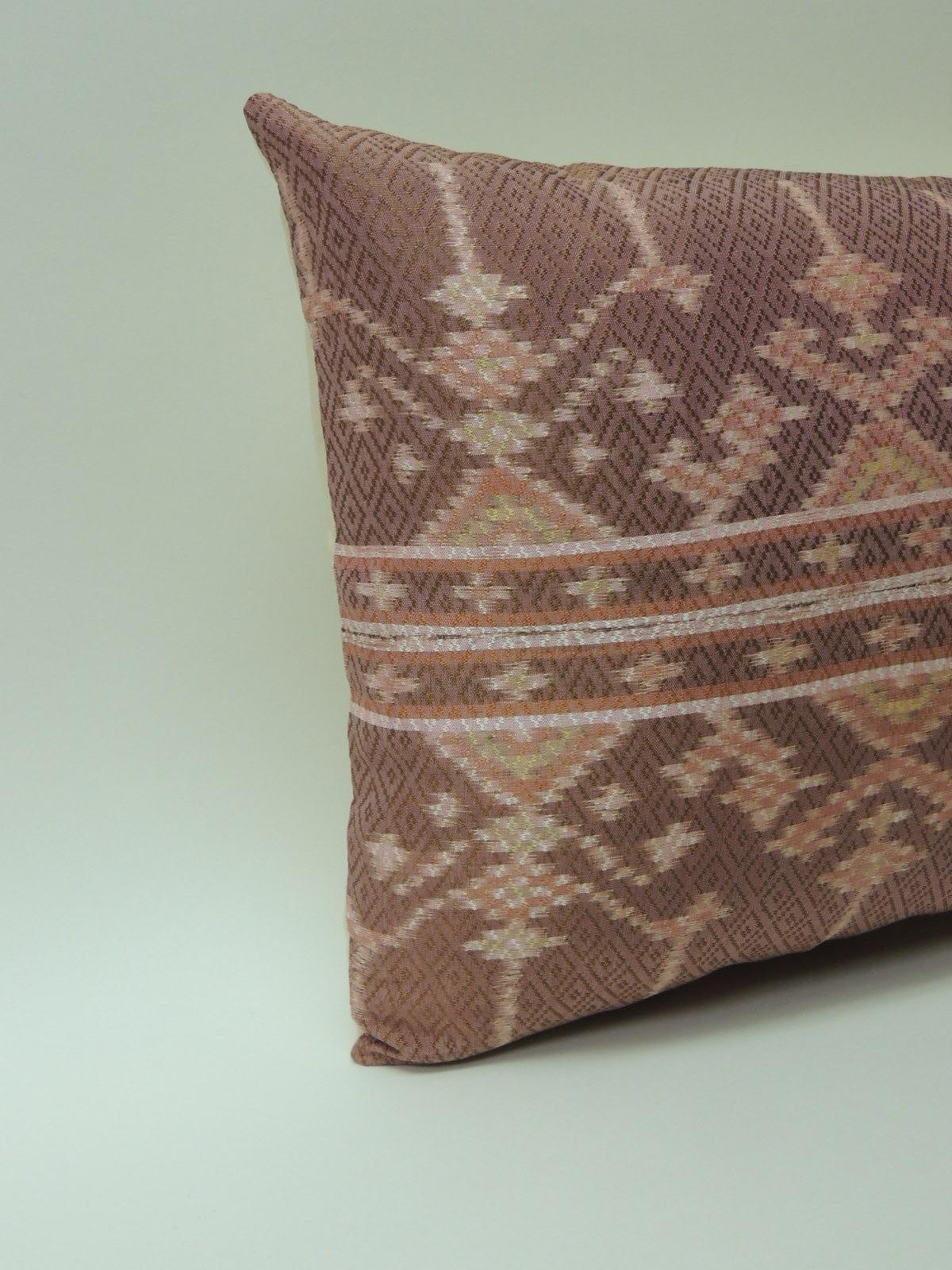 Vintage woven pink silk Ikat decorative lumbar pillow
Vintage silk Ikat woven textile decorative lumbar pillow. Traditional Asian woven pink textile with tribal design in the front panel. Decorative lumbar pillow finished with ecru silk backing.