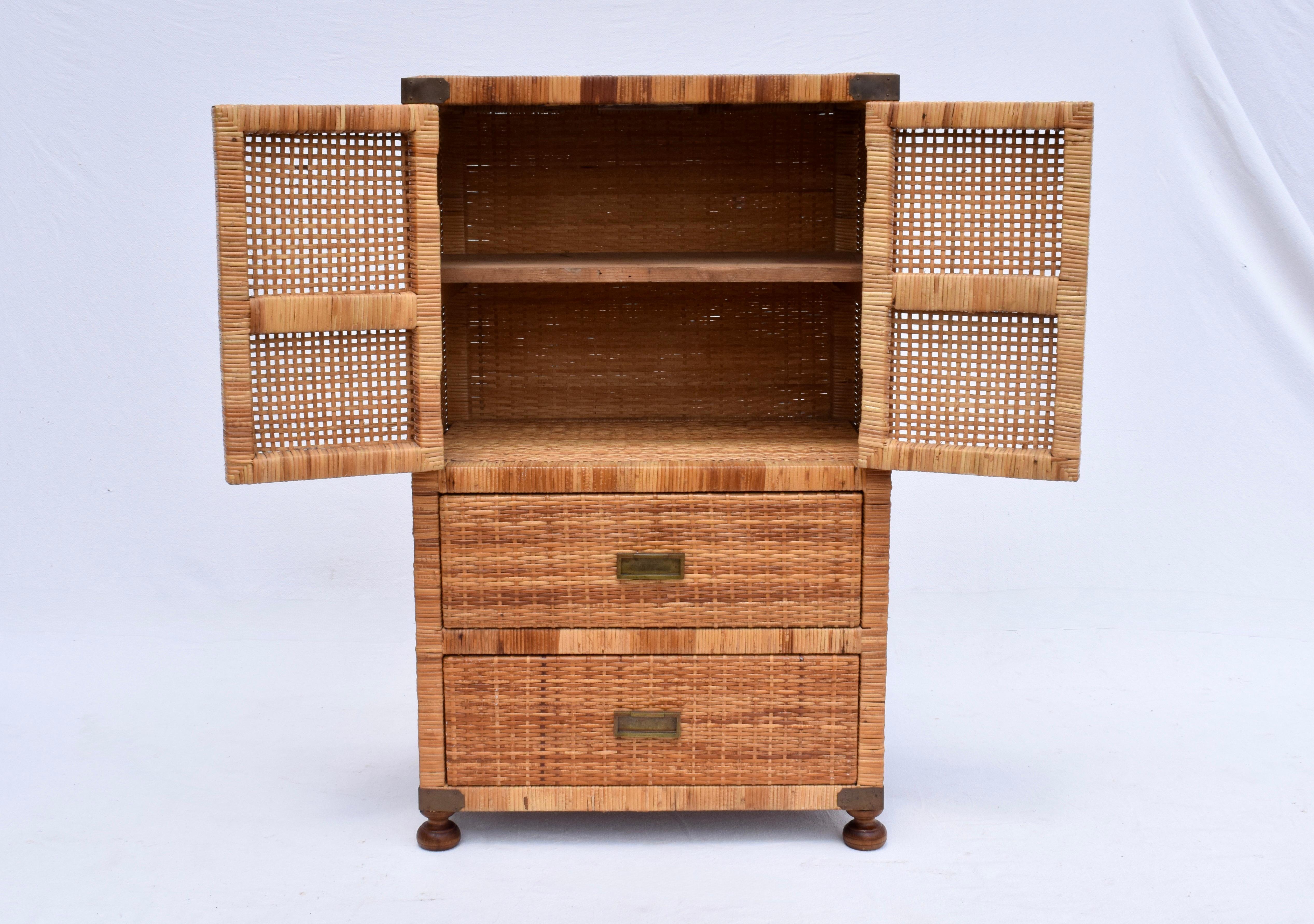 Mid 20th Century Campaign style woven rattan two door cabinet with one removable shelf & two drawers on bun feet. Very sweet multifunctional storage ready for use.