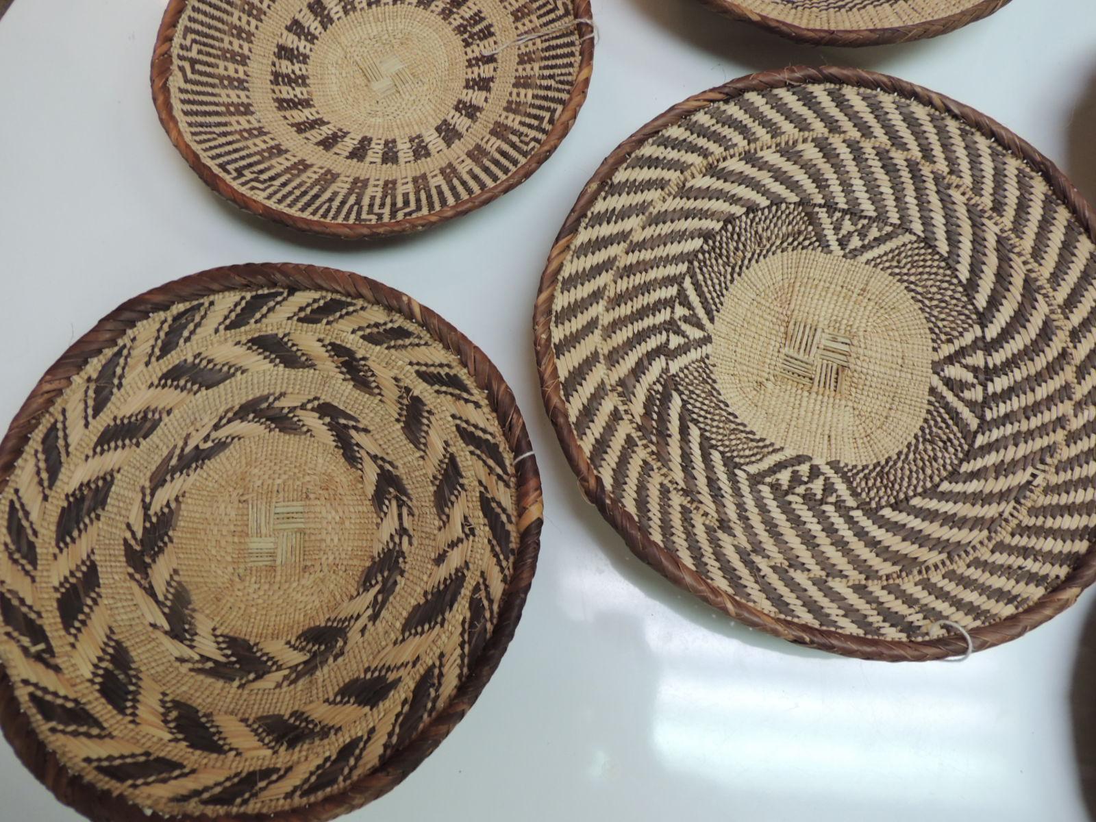 Vintage woven seagrass ethnic round African flat baskets
Set of six (6) artisanal handwoven baskets with tribal designs and patterns all around.
Range in size from 9.5 inches - 10 inches and 11.5 inches
Africa, 1980s.


 