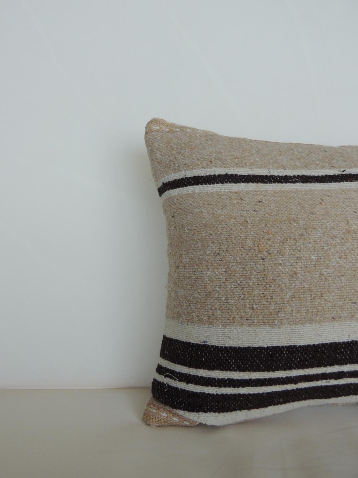 Vintage African woven tribal artisanal textile decorative pillow with jute trim.
Tunisian vintage artisanal tribal textile decorative pillows handcrafted from the vintage wool and hemp hand-loomed by the Berber tribes from the Atlas Mountains of