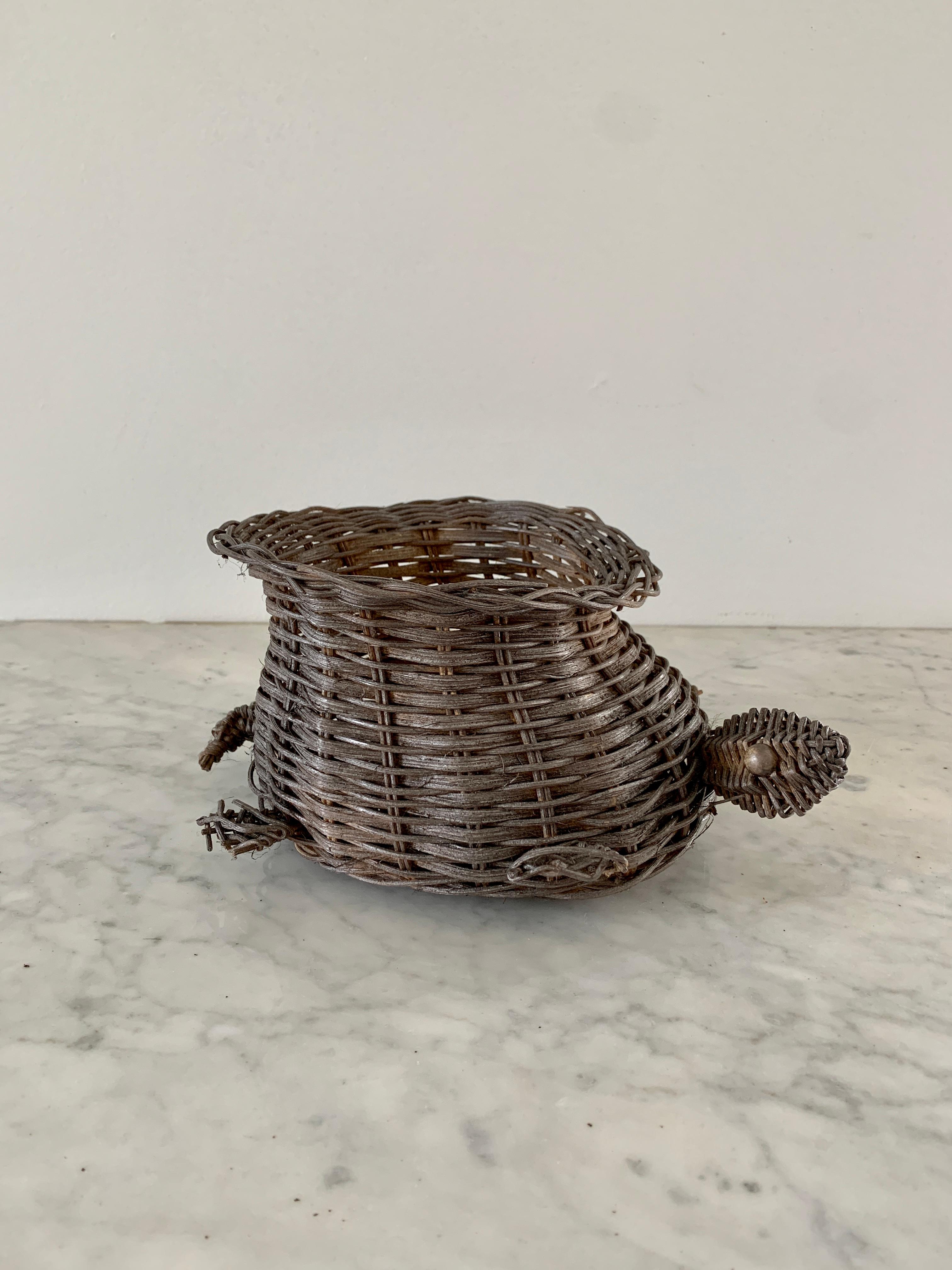 A gorgeous woven wicker basket in the form of a turtle, perfectly wonky to add character to any space. This piece could be used as a catchall or to hold a potted plant.

USA, circa 1970s.

Measures : 10