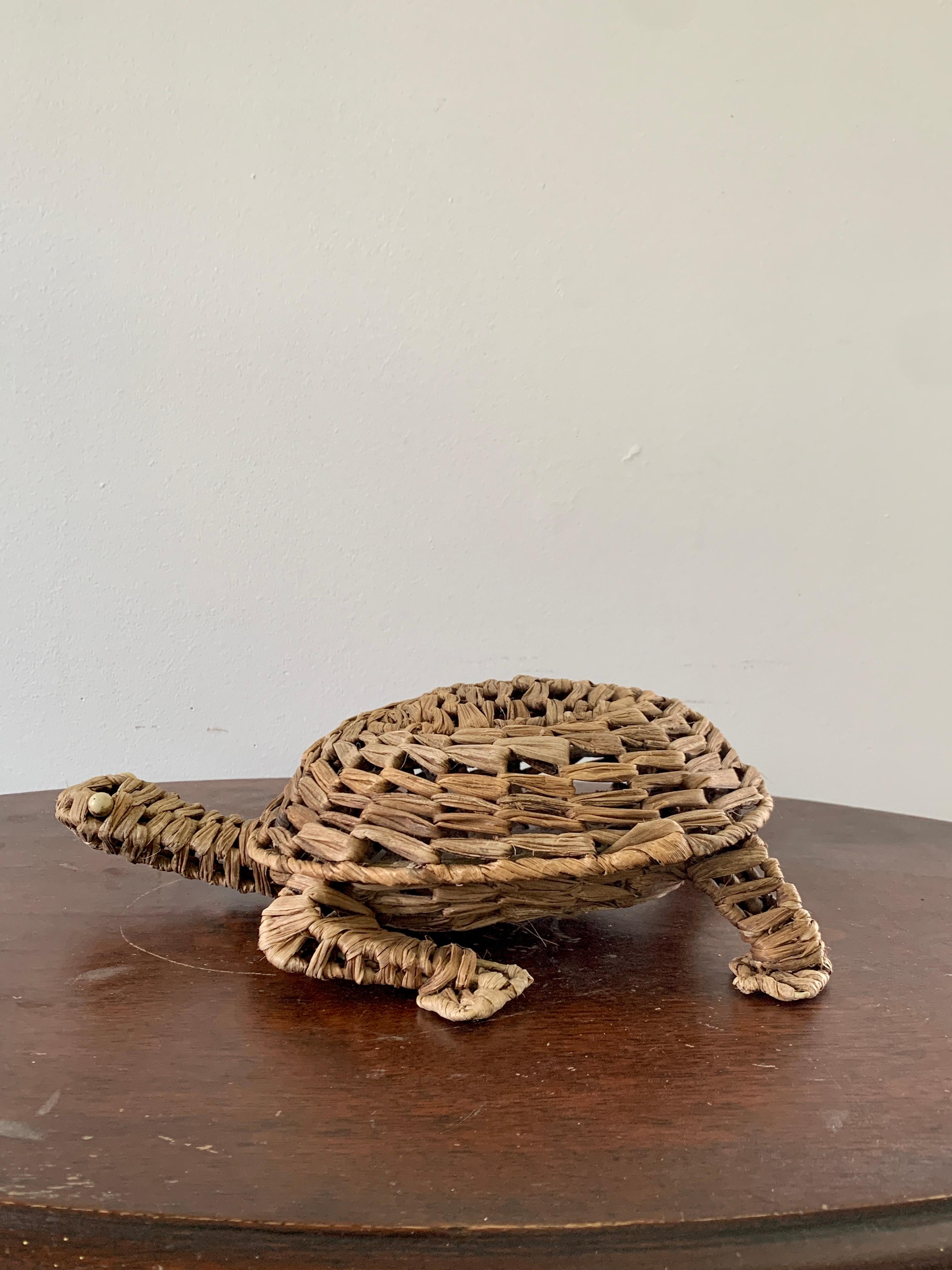 A charming woven wicker footstool in the form of a turtle, perfectly wonky to add character to any space. This piece could also be used as decor on a tabletop or shelf.

USA, Mid-20th Century

Measures: 14