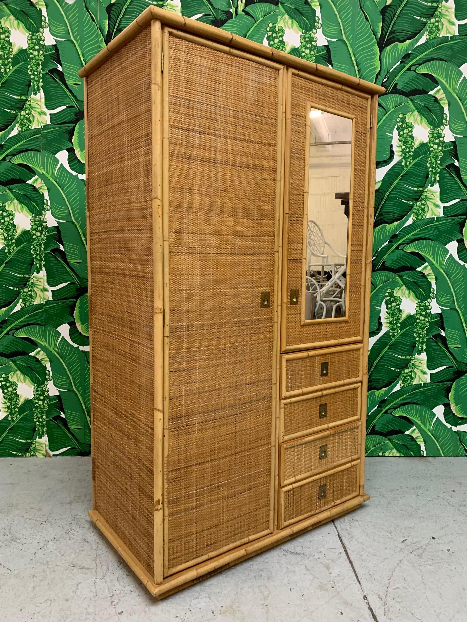 Large bamboo and woven wicker armoire features large storage spaces with clothes rods as well as 4 drawers. Bamboo detailing along all edges. Good condition other than crack on back side of cabinet. Can be seen from inside left cabinet door.