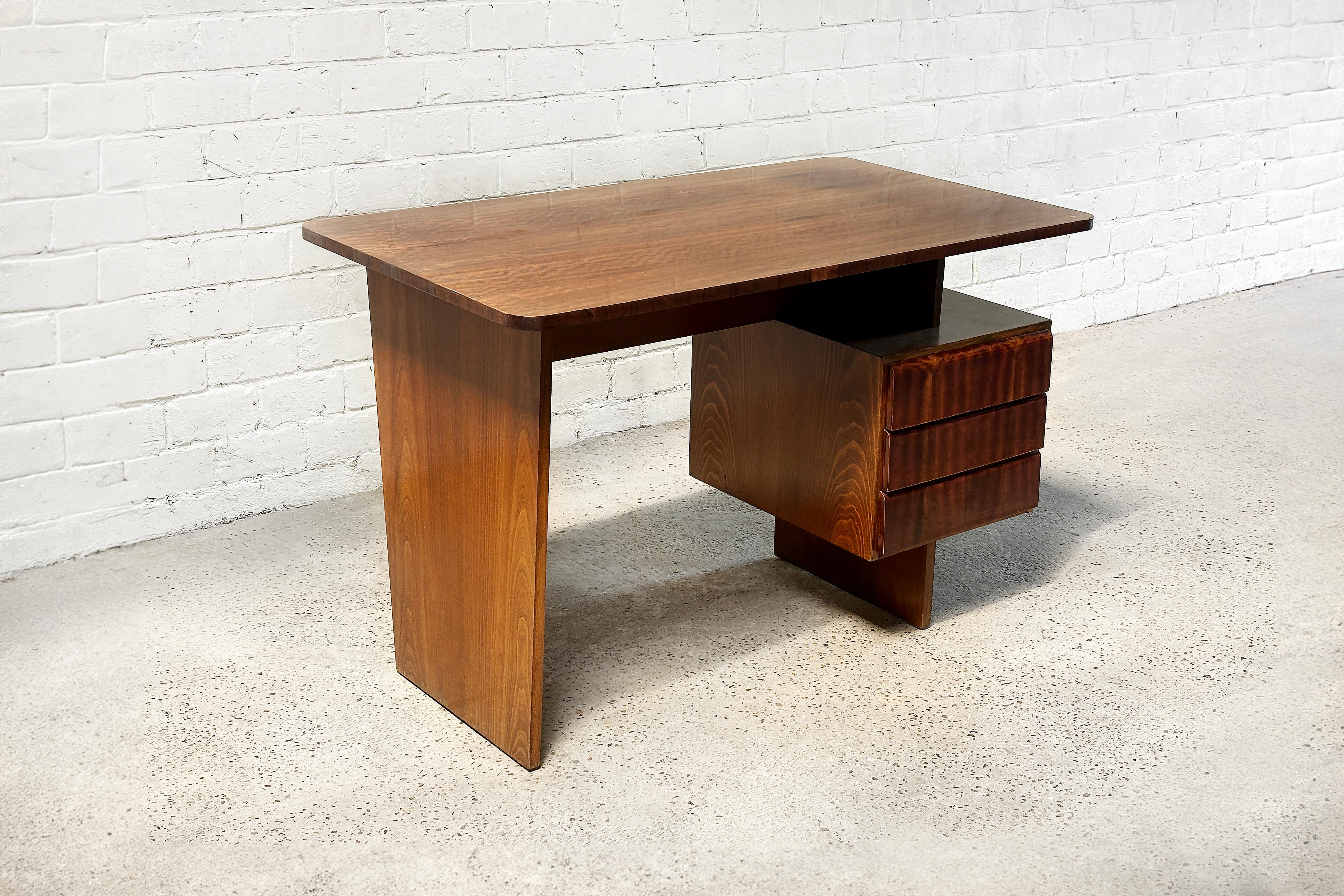 A warm beech wood desk, designed by Bohumil Landsman and produced in the 1970s in former Czechoslovakia. This piece showcases the distinctive modernist style typical of Eastern European design from that era. In good condition. Light wear consistent
