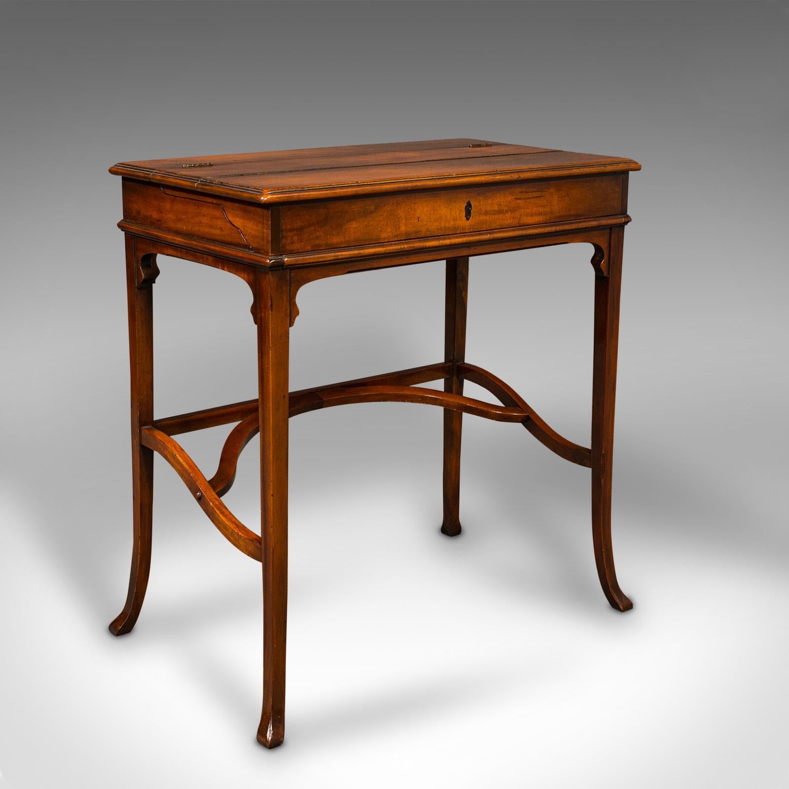 This is a vintage writing desk. An English, mahogany articulated bureau de plait, dating to the late 20th century, circa 1980.

Fascinating articulated top, with an appealing finish for the keen writer
Displays a desirable aged patina and in good