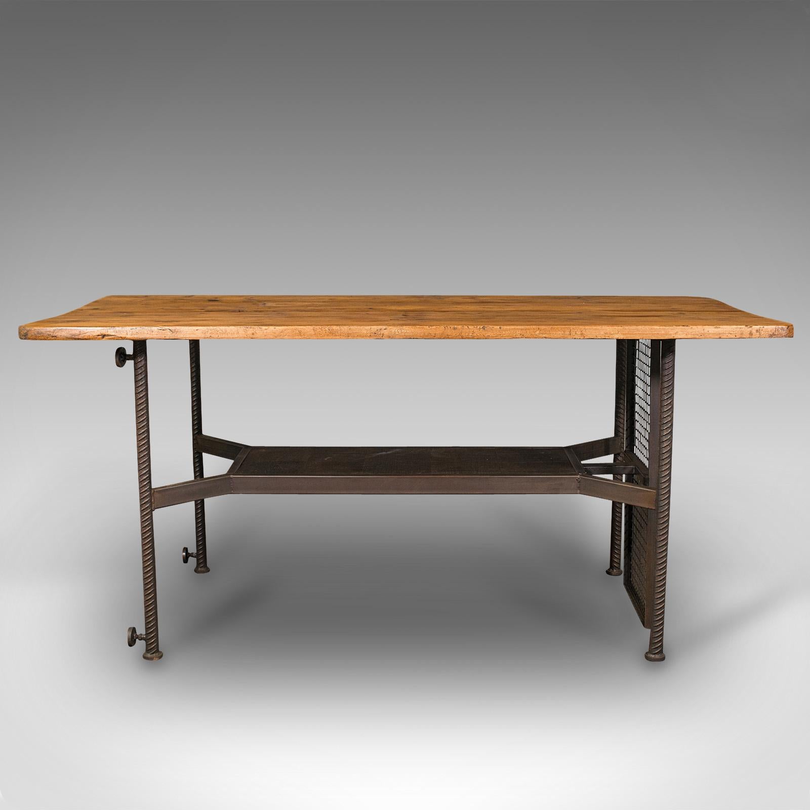 This is a vintage writing desk. An English, steel, oak and Victorian pine shop retail display table, dating to the late 20th century, circa 1990.

Fascinatingly distinctive writing desk or retail shopfitting.
Displays a desirable aged patina
