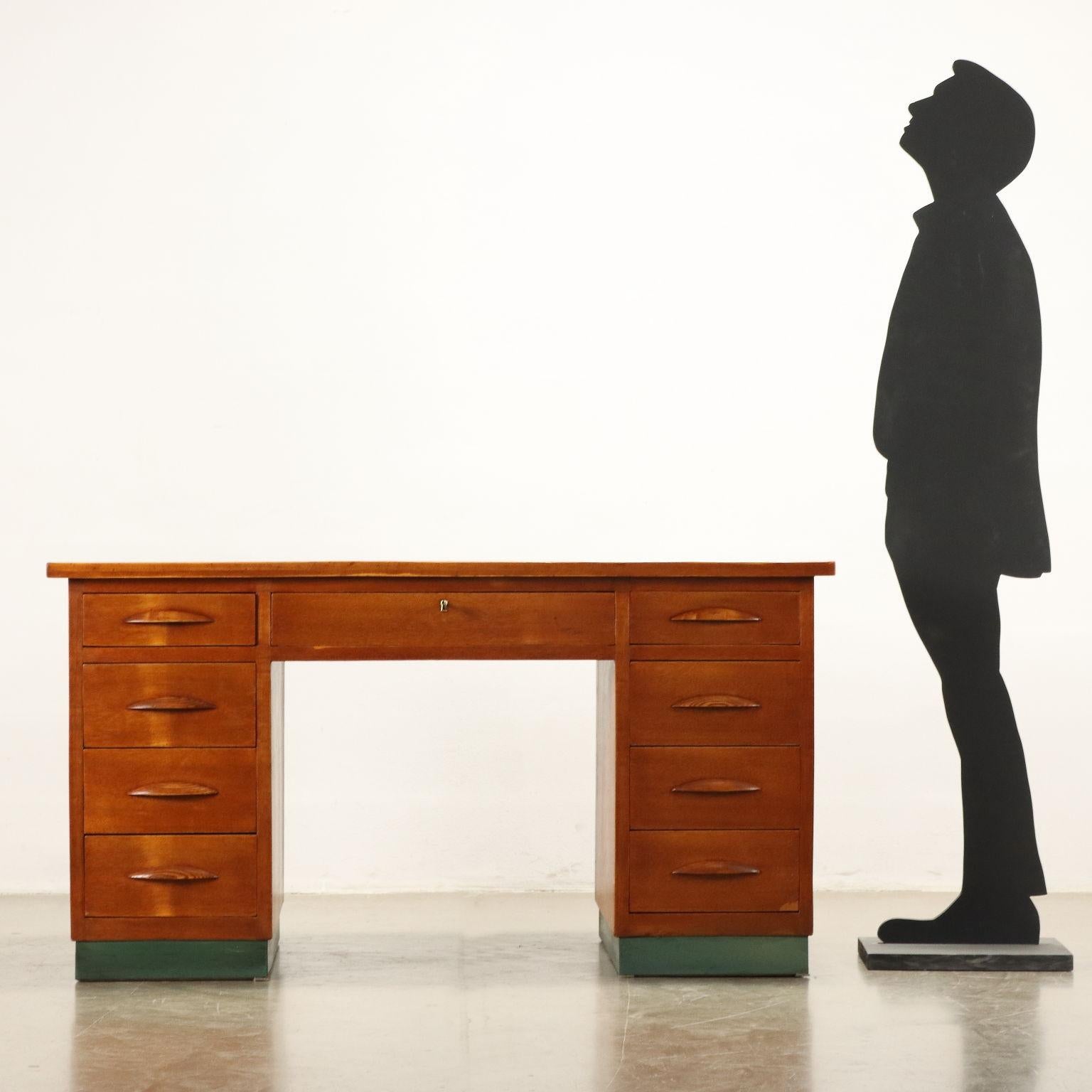 Desk with side drawers and under-top drawer in oak veneered wood with linoleum top.