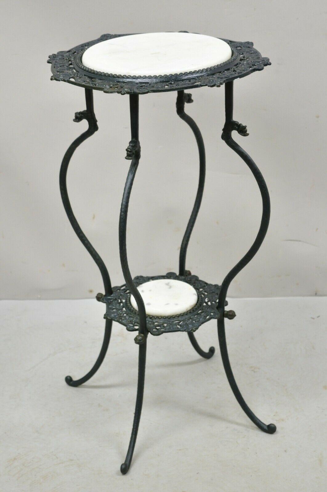 Vintage wrought iron 2 tier white round marble Victorian plant stand. Item features 2 tier of round marble, green painted finish, wrought iron construction, very nice vintage item, great style and form. Circa mid to late 20th century. Measurements: