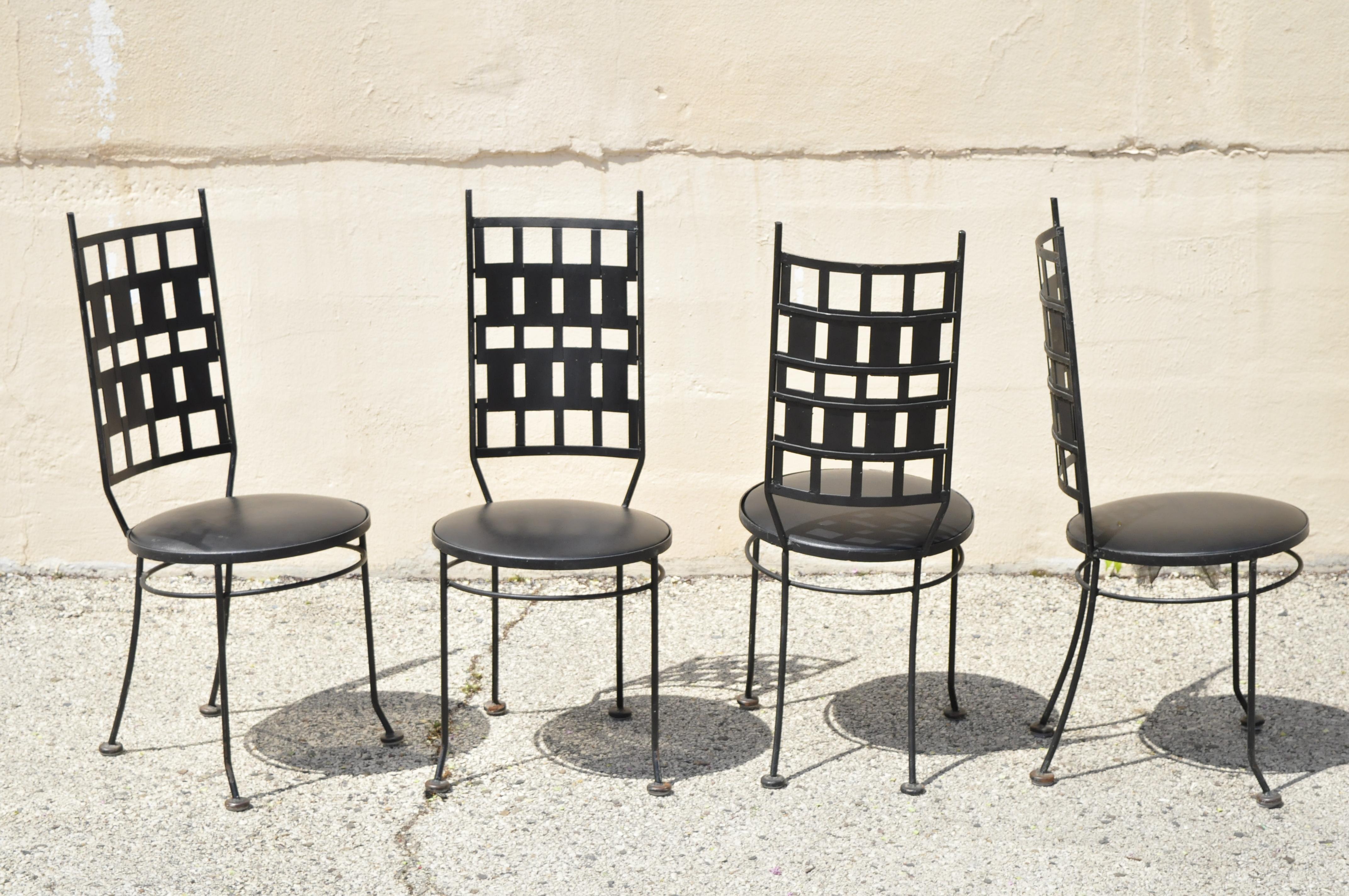 Vintage wrought iron atomic era Italian style Mid-Century Modern dining chairs - set of 4. Item features round naugahyde upholstered seats, wrought iron construction, very nice vintage set, clean modernist lines, great style and form, Circa mid 20th