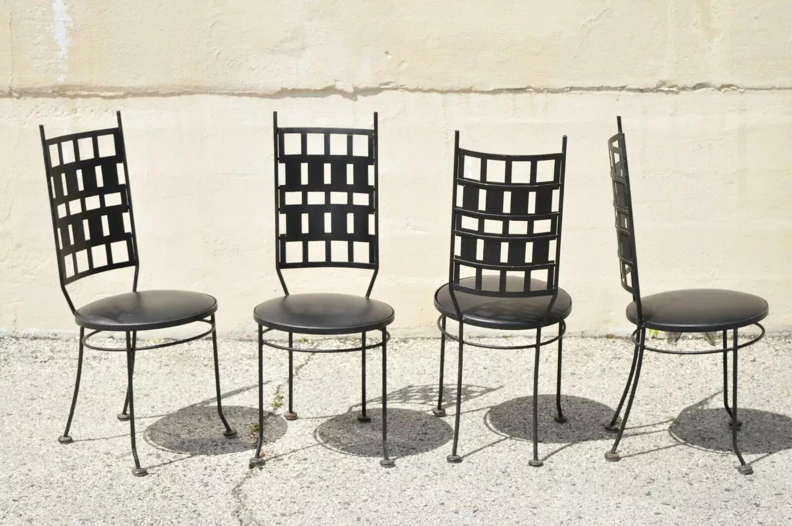 Vintage Wrought Iron Atomic Era Mid Century Modern Dining Chairs after Maurizio Tempestini - Set of 4. Item features round vinyl upholstered seats, wrought iron construction, very nice vintage set, great style and form. Circa Mid 20th Century.