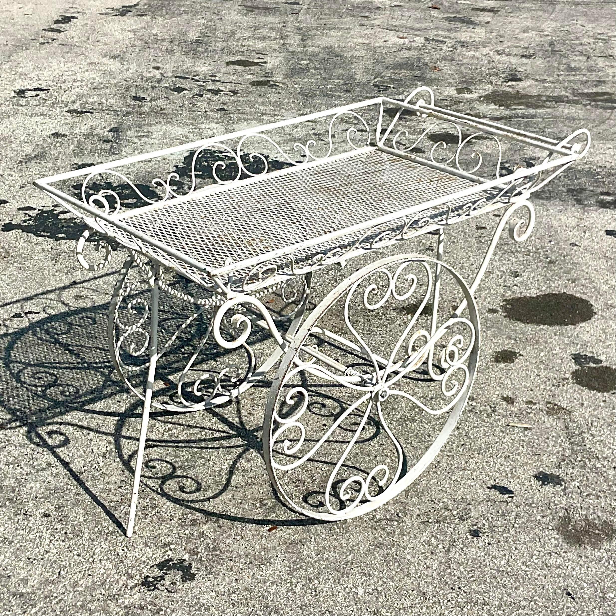 A fantastic vintage MCM bar cart. Beautiful wrought iron with a fabulous big wheel design. Acquired from a Palm Beach estate.