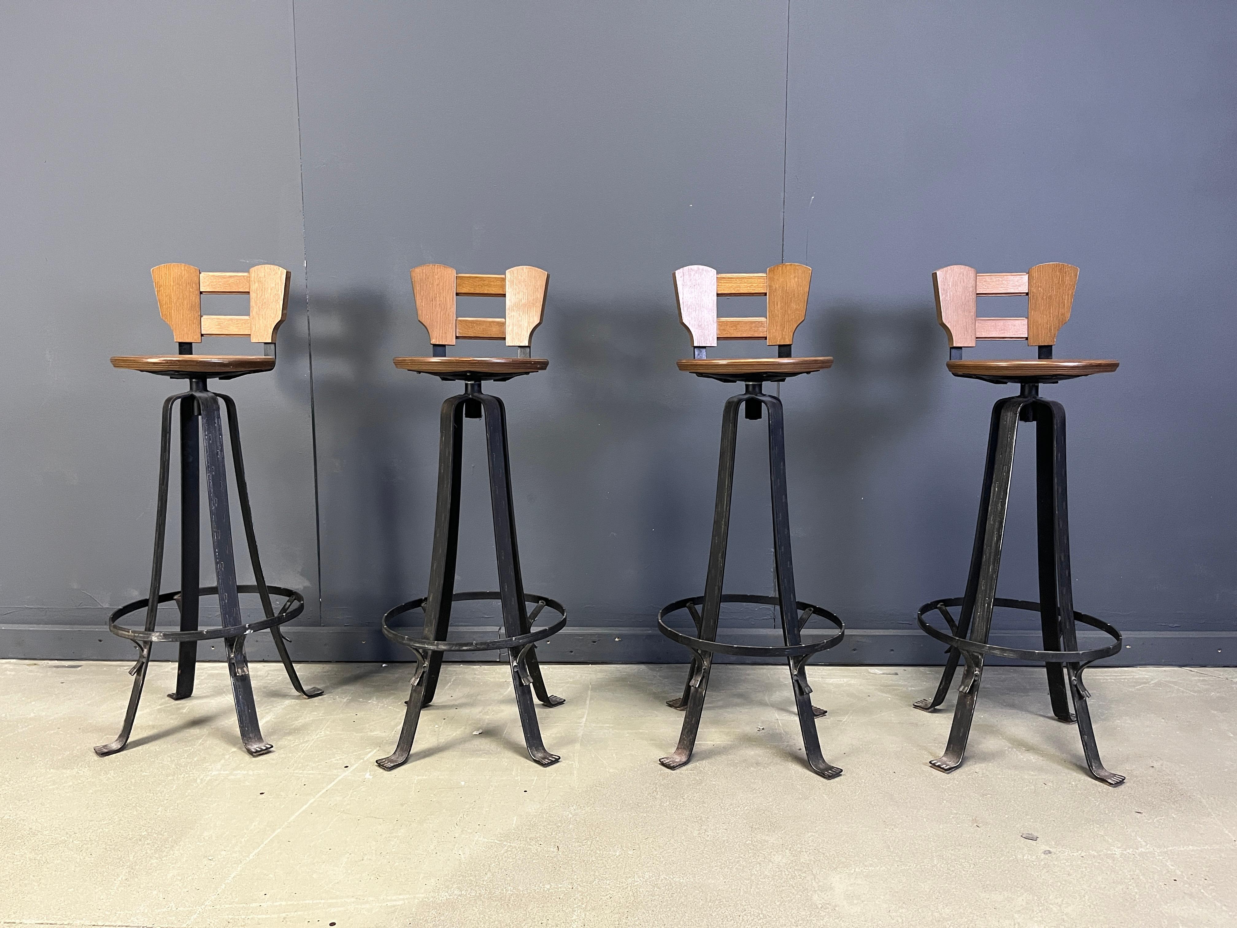 Vintage brutalist bar stools with elegant wrought iron bases and wooden seats and backrests.

These bar stools are very robuste and have a nice look to them.

1970s - Germany

Dimensions:
Height: 105cm/42.78