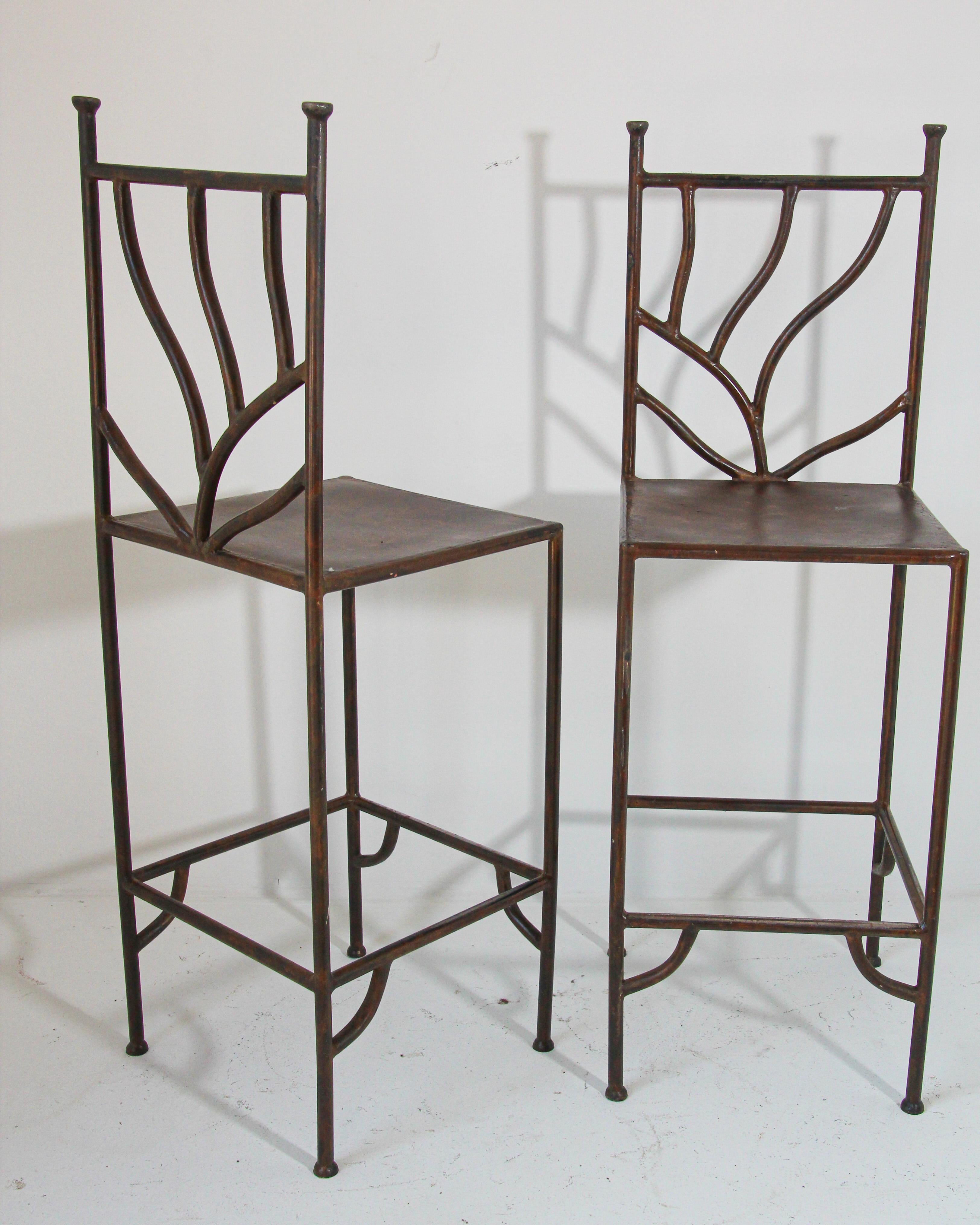 Custom made vintage Spanish Revival wrought iron barstools hand-crated stools featuring linear wrought iron frames seats of thick patinated metal.
Vintage rustic wrought iron hand forged barstools with back.
Set of two barstools, heavy iron Spanish