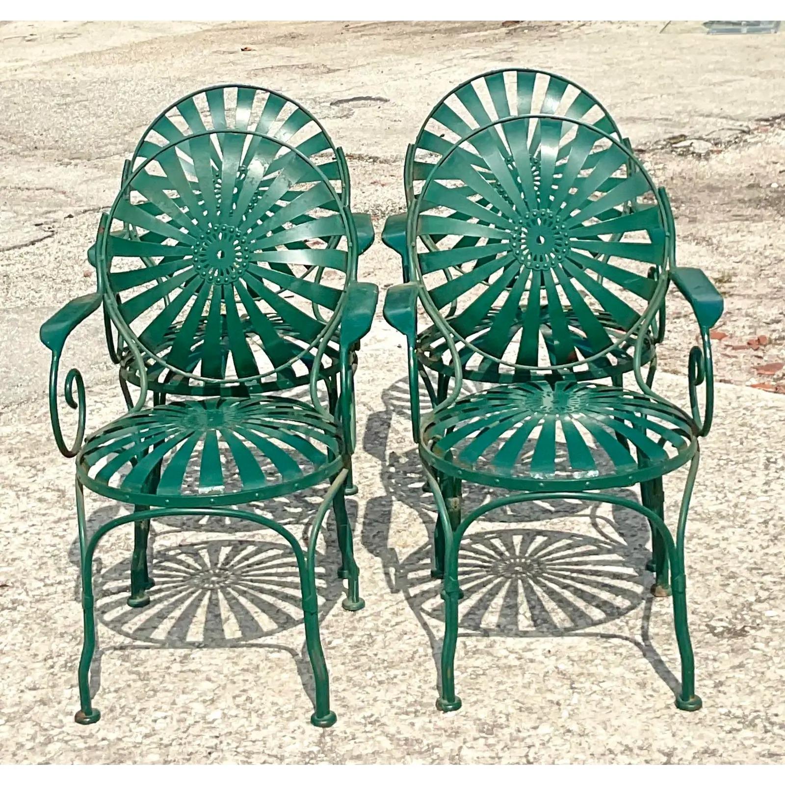 Fantastic set of 4 vintage wrought iron dining chairs. Designed by the iconic Francois Carre. Super coveted pinwheel style. Acquired from a Palm Beach estate.