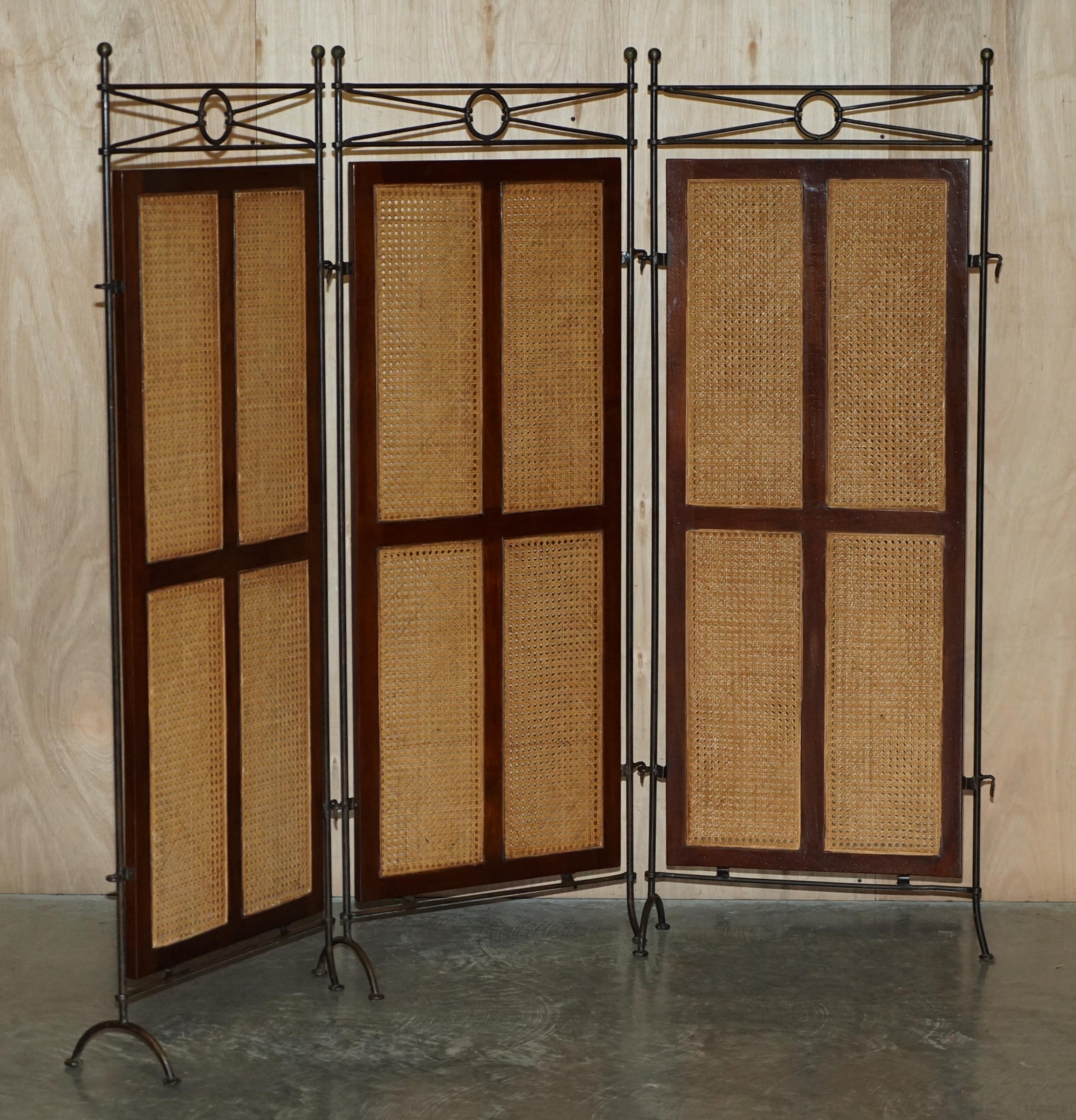 We are delighted to offer for sale this lovely triple panel, wrought iron, bergere and mahogany framed free standing room divider.

A very good looking well made and decorative room divider, the three panels can be used alone or they link in to
