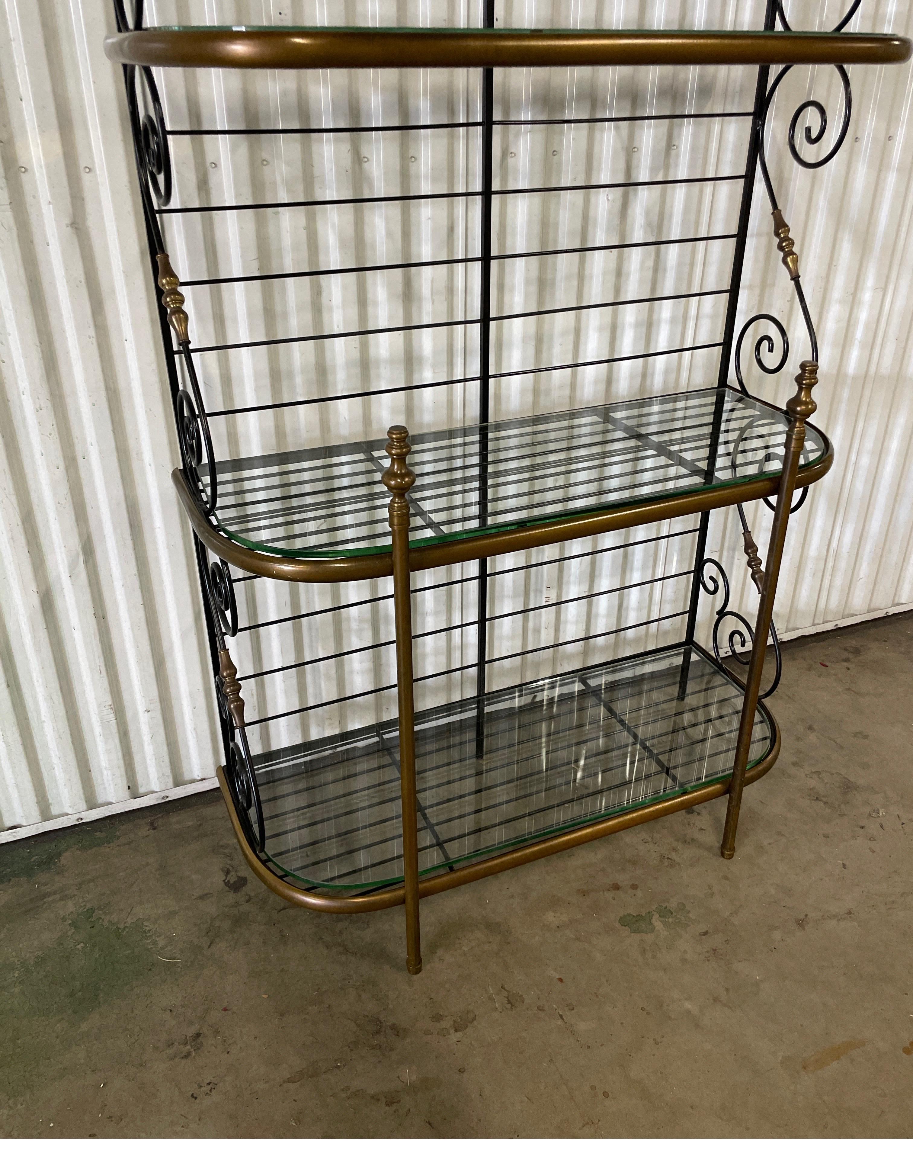 Vintage wrought iron and brass three shelf French Baker's Rack. Glass was a later addition to the shelves. Scrolled details on side & top. Very nice condition with patinated brass trim.