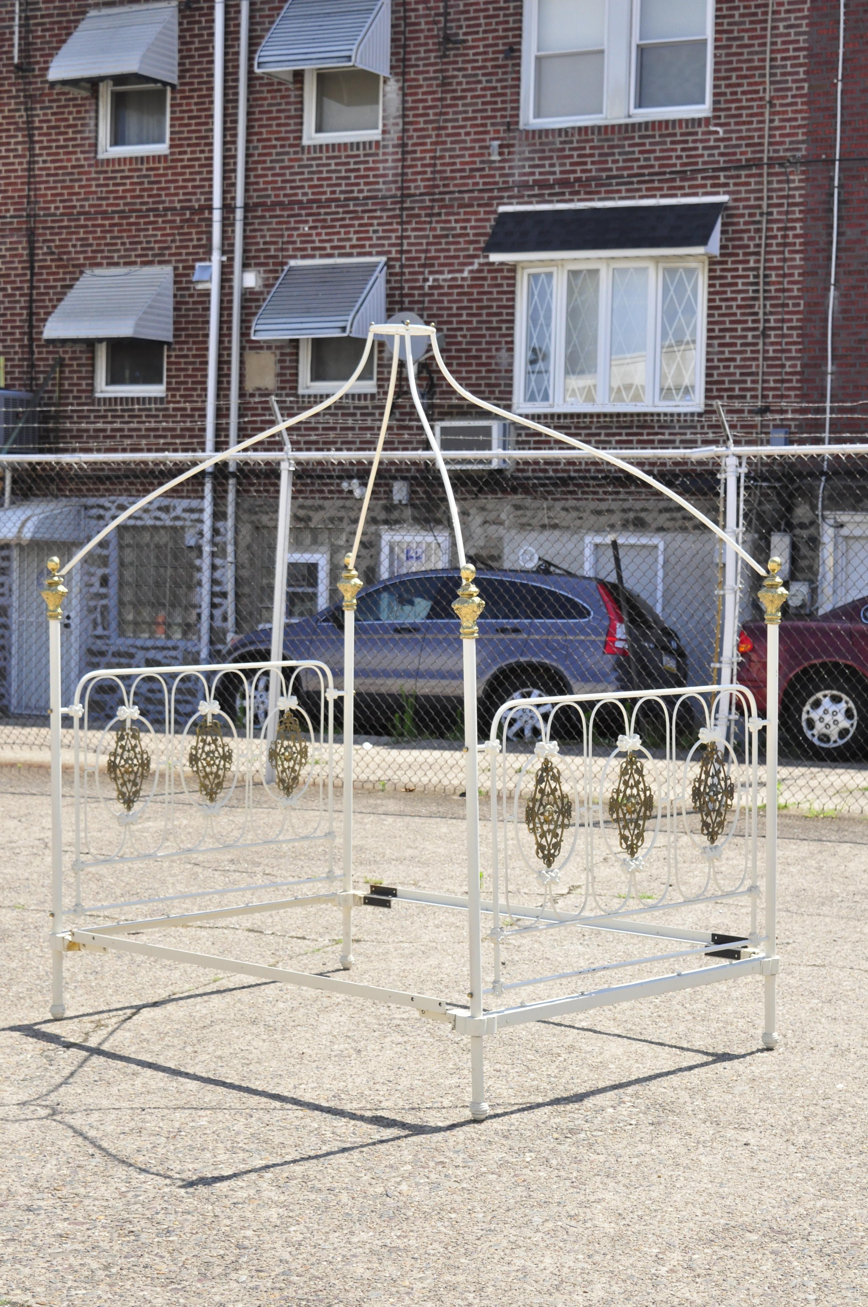 Vintage wrought iron and brass French Victorian style full size poster bed frame with canopy. Item features removable canopy, cast brass ormolu, brass finial posts, full size frame, very nice vintage item, great style and form. Circa Mid 20th