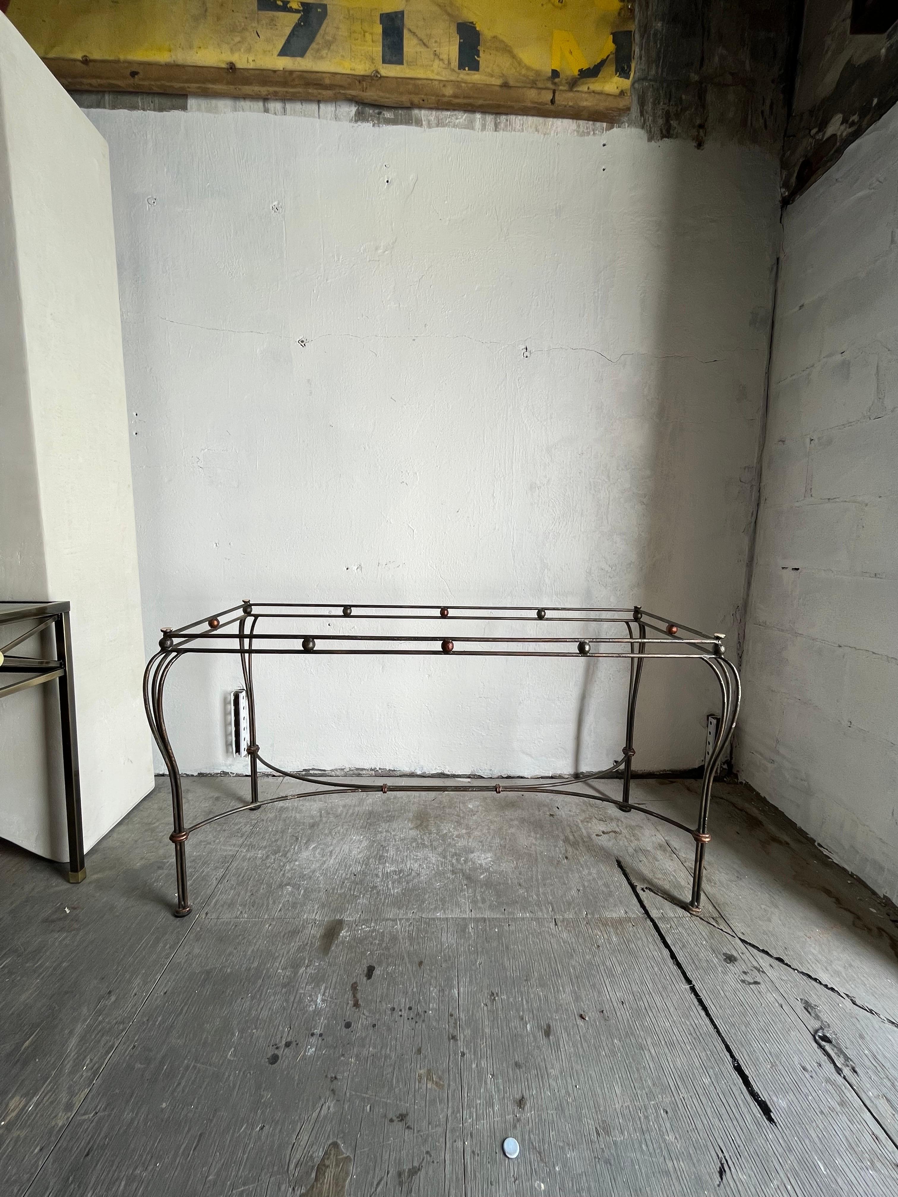 Modern Classic lines. Glass top console table with wrought iron base. Subtle detail with brass ball and wrapped stretchers in the manner of  Marc du Plantier.
Curbside to NYC/Philly $350