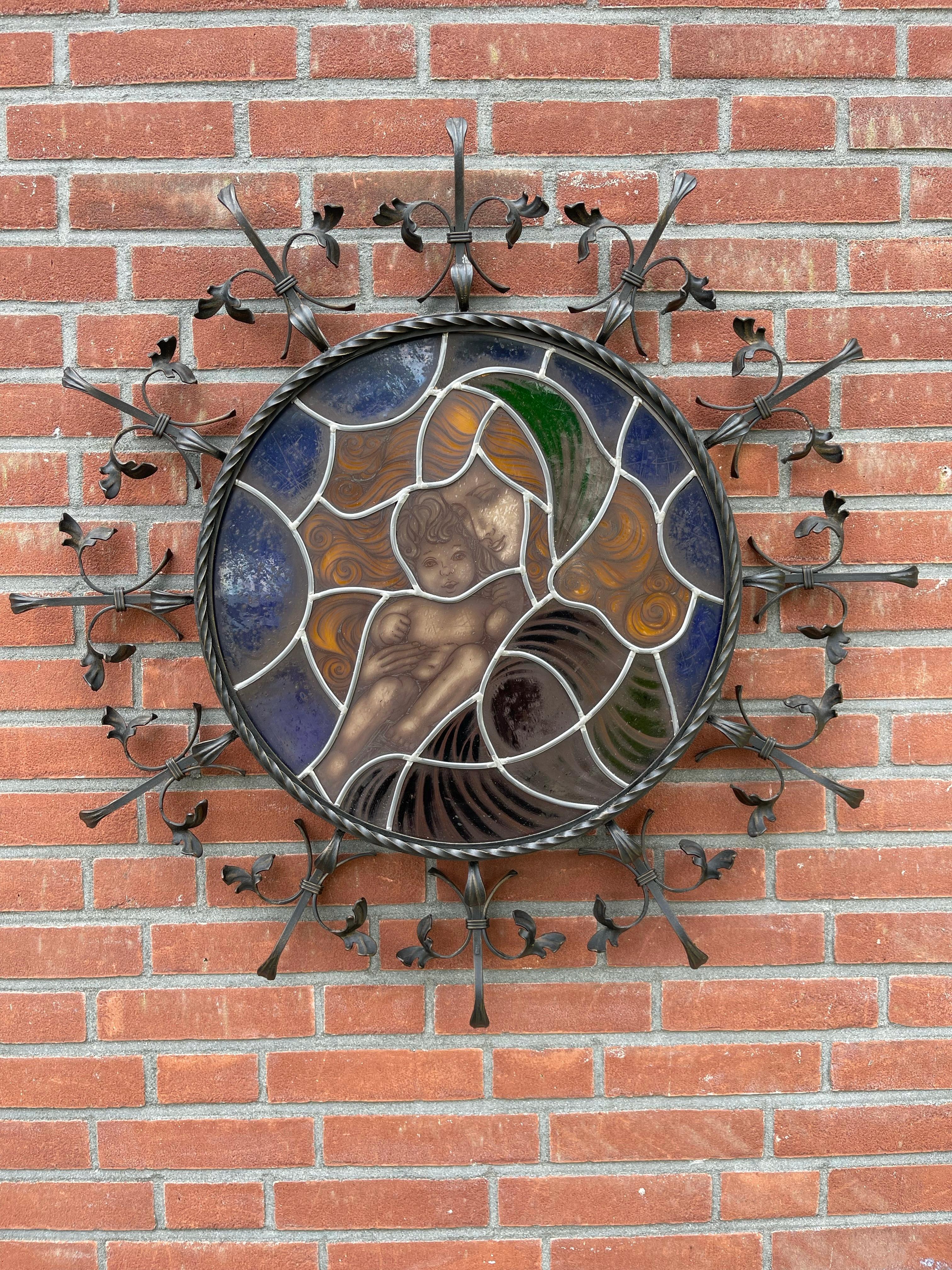 Meaningful and exceptional quality leaded glass wall fixture, with painted Madonna & Child.

This work of religious art from the early 1950s combines masterful craftsmanship with timeless symbolism. At its center, the hand-painted leaded glass