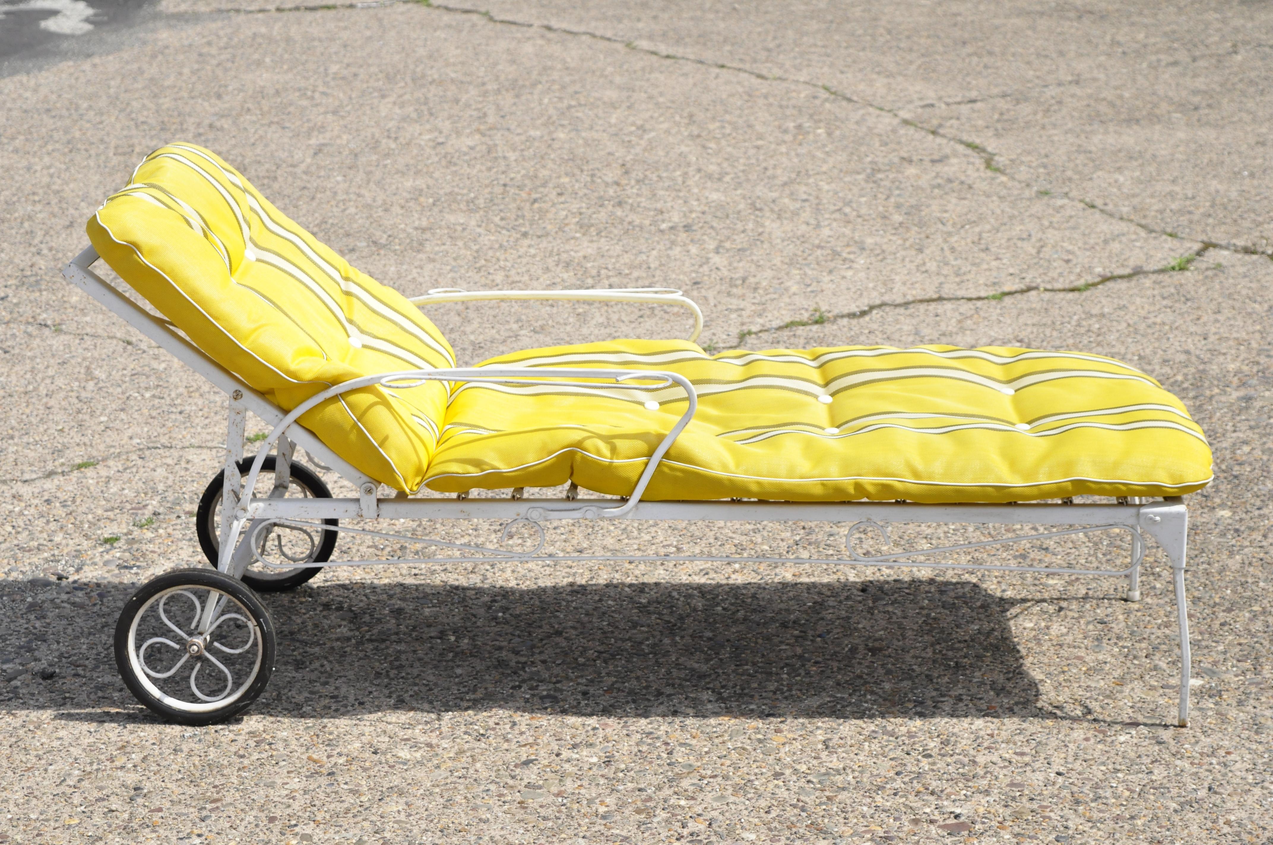 Vintage wrought iron garden patio adjustable chaise lounge chair with yellow cushion. Item features yellow loose cushion, adjustable back, 2 wheels, white painted finish, wrought iron construction, very nice vintage item, great style and form. Circa